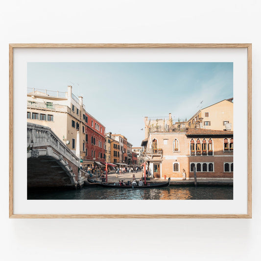 Framed photo called A Day in Venice with gondolas and historic buildings under a blue sky.