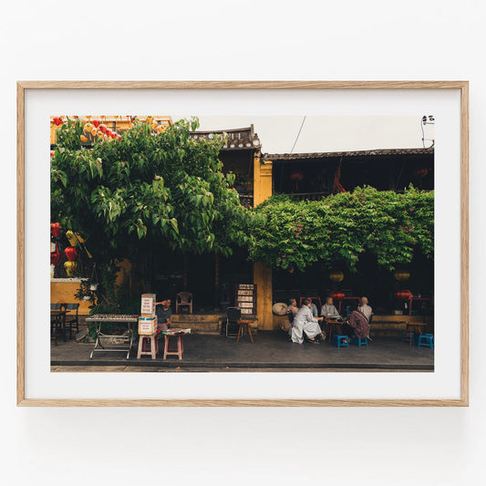 Framed photo Afternoon in Hoi An with a leafy tree, people sitting, and a yellow building in the background.