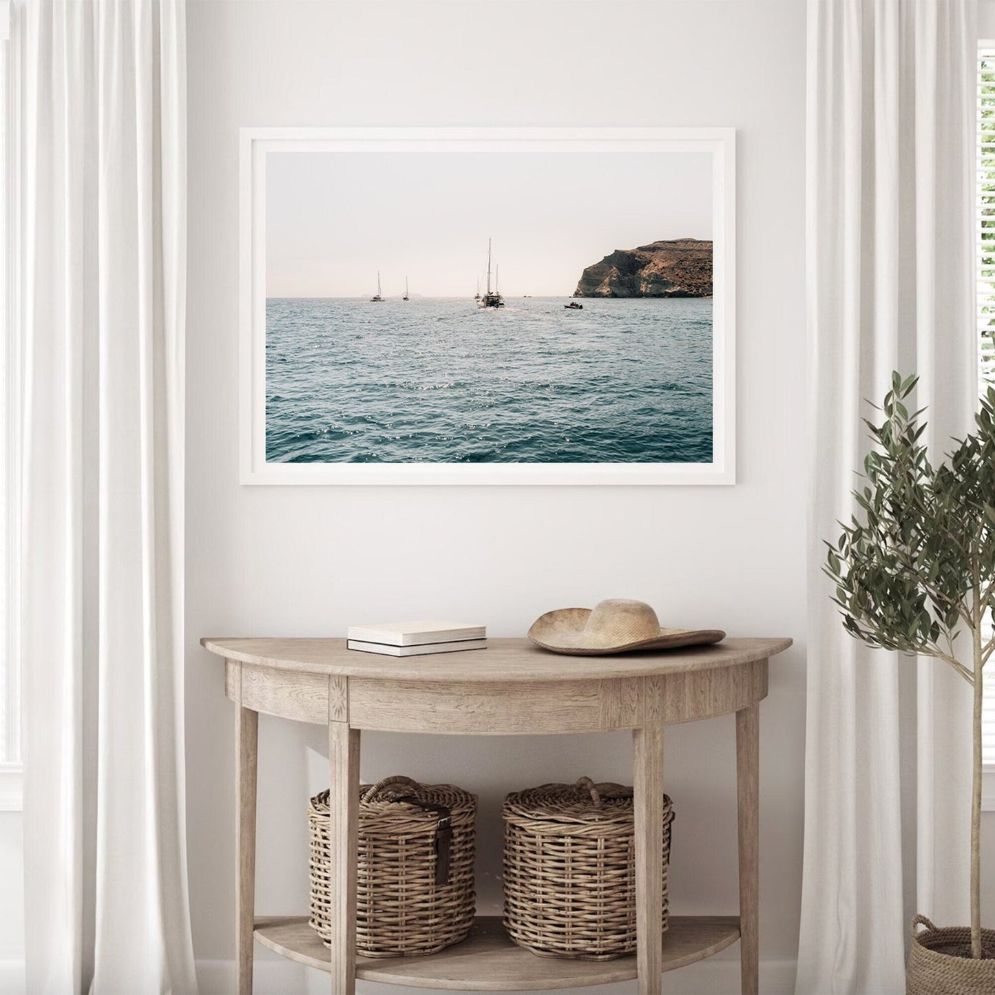 A serene room with Afternoon Sail II above a wooden table, wicker baskets underneath, and light curtains flanking.