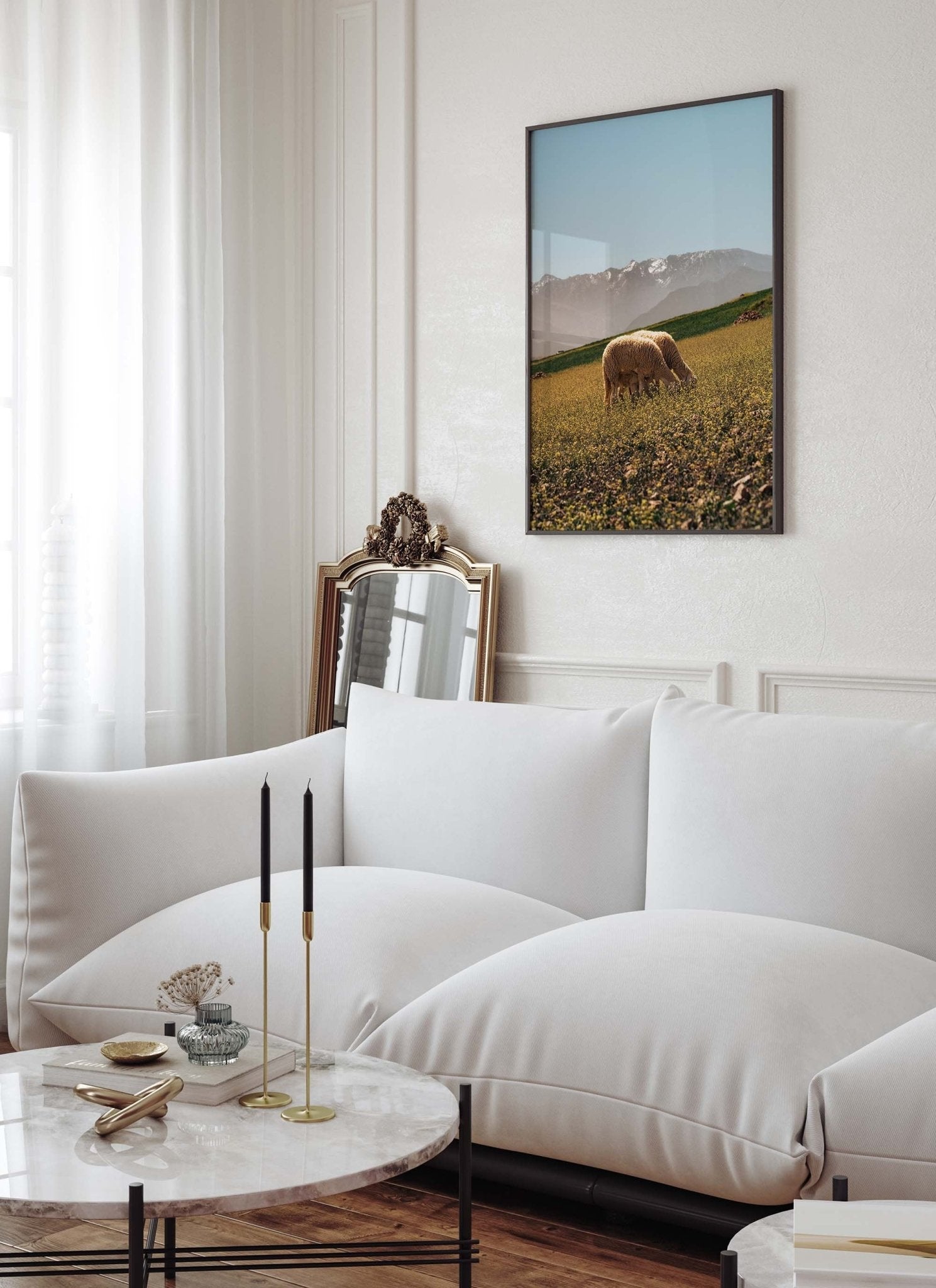 Modern living room with a white sofa, marble table, and framed Atlas Mountains II landscape photo.