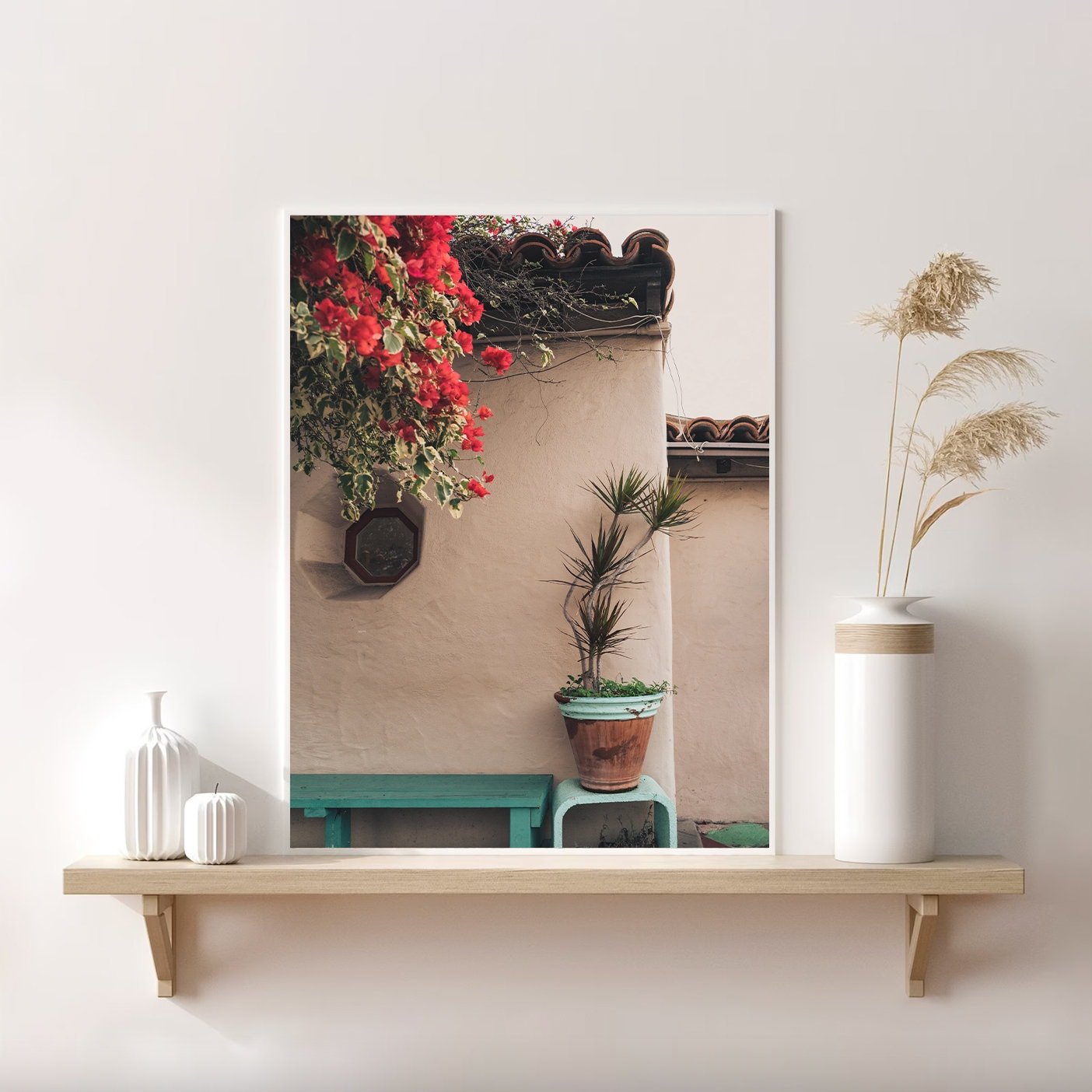 The Balboa Charm: a framed photo of a patio with flowers, plants on a wooden shelf, and white decorative vases.
