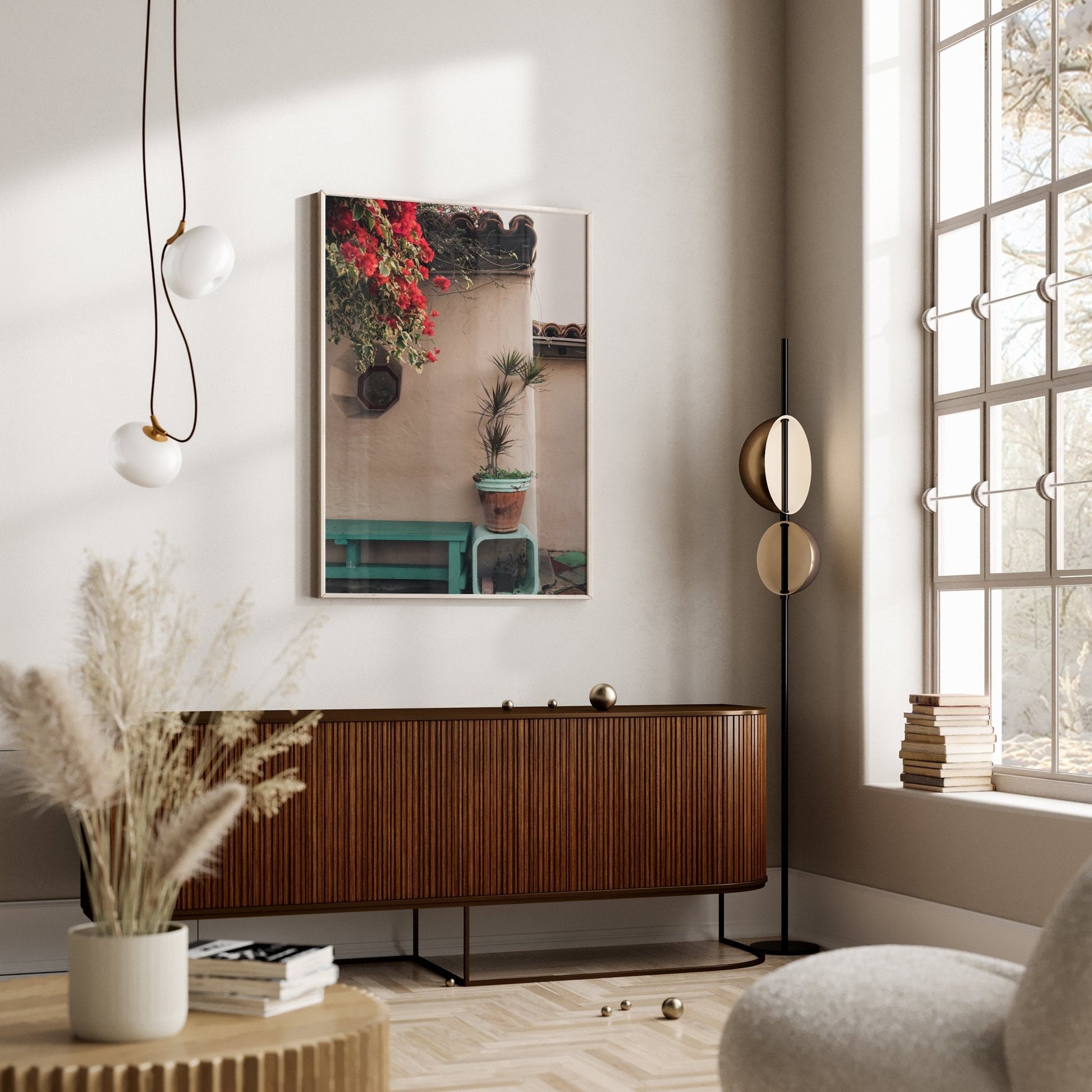 The modern living room features the Balboa Charm sideboard, plant artwork, hanging lamps, and a large window with natural light.
