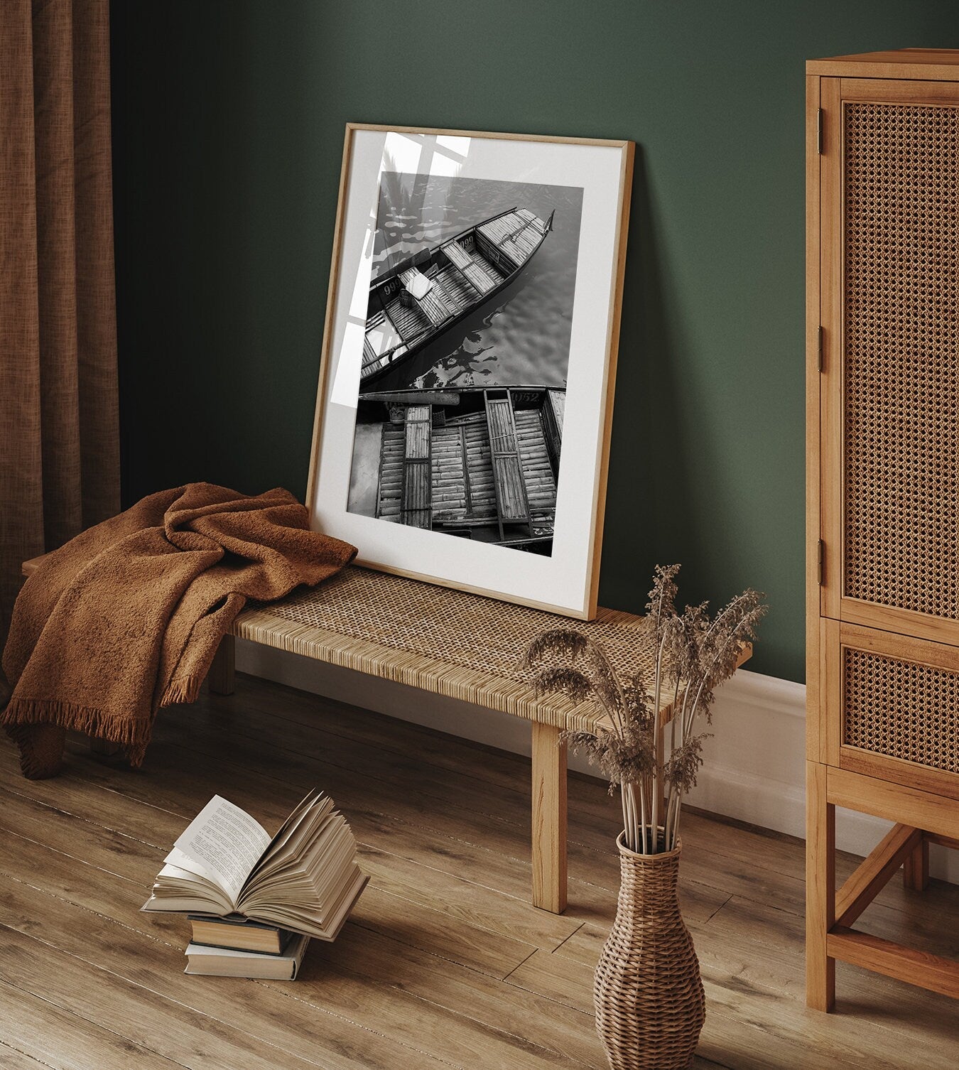 Cozy room with Bamboo Boat I Black and White photo on a bench, an open book on the floor, and a vase with dried plants.