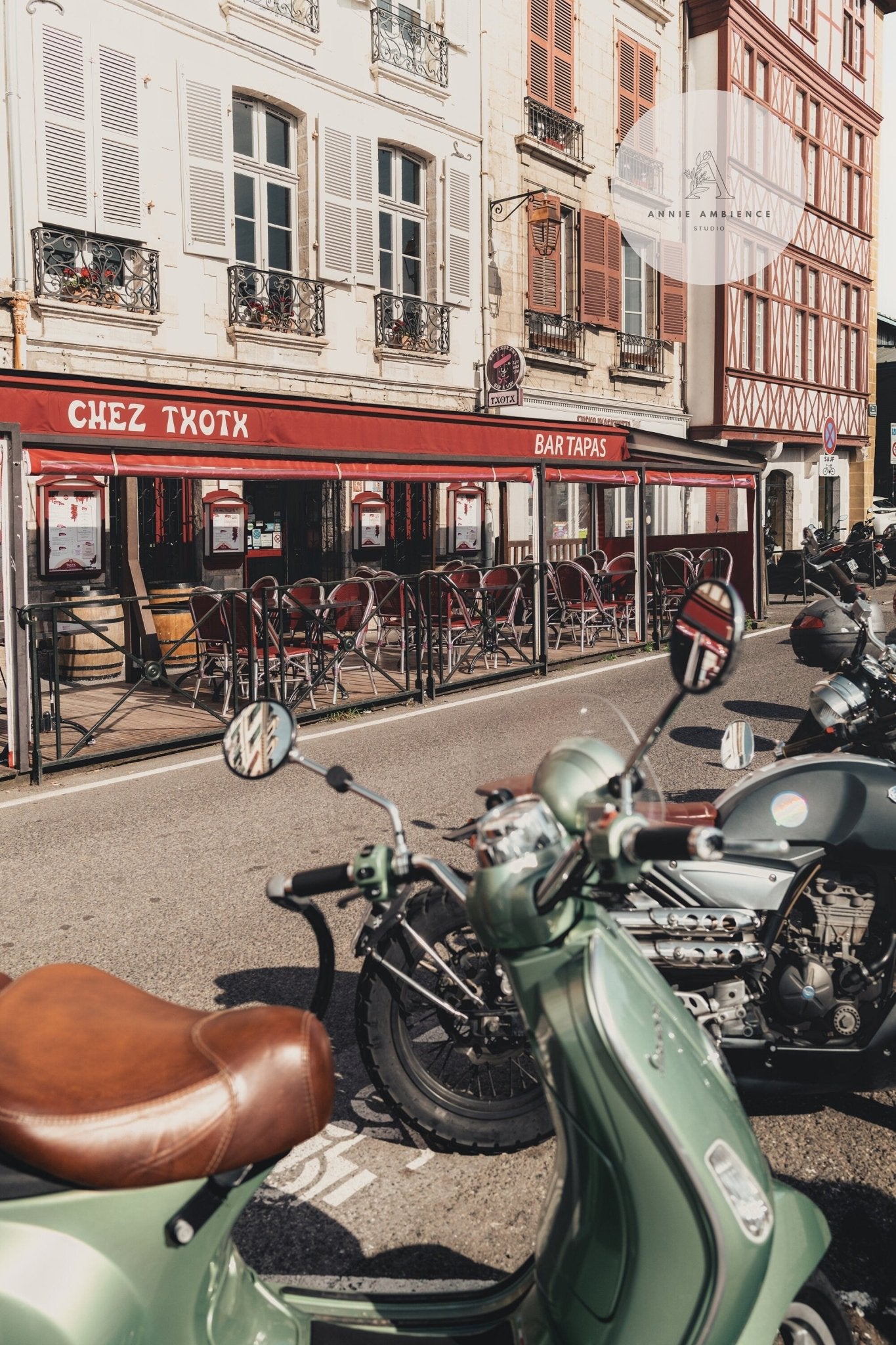 Bayonne Vespa parked outside a tapas bar with European architecture in the background.