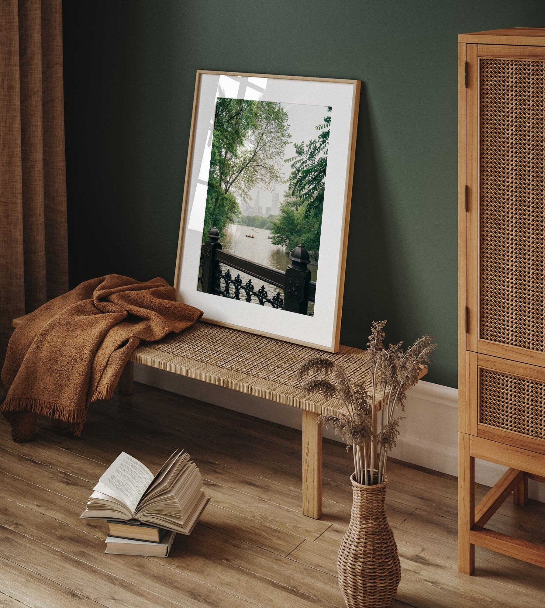 Beyond the Bridge photo on a bench with a book, vase, and woven cabinet in a cozy room.