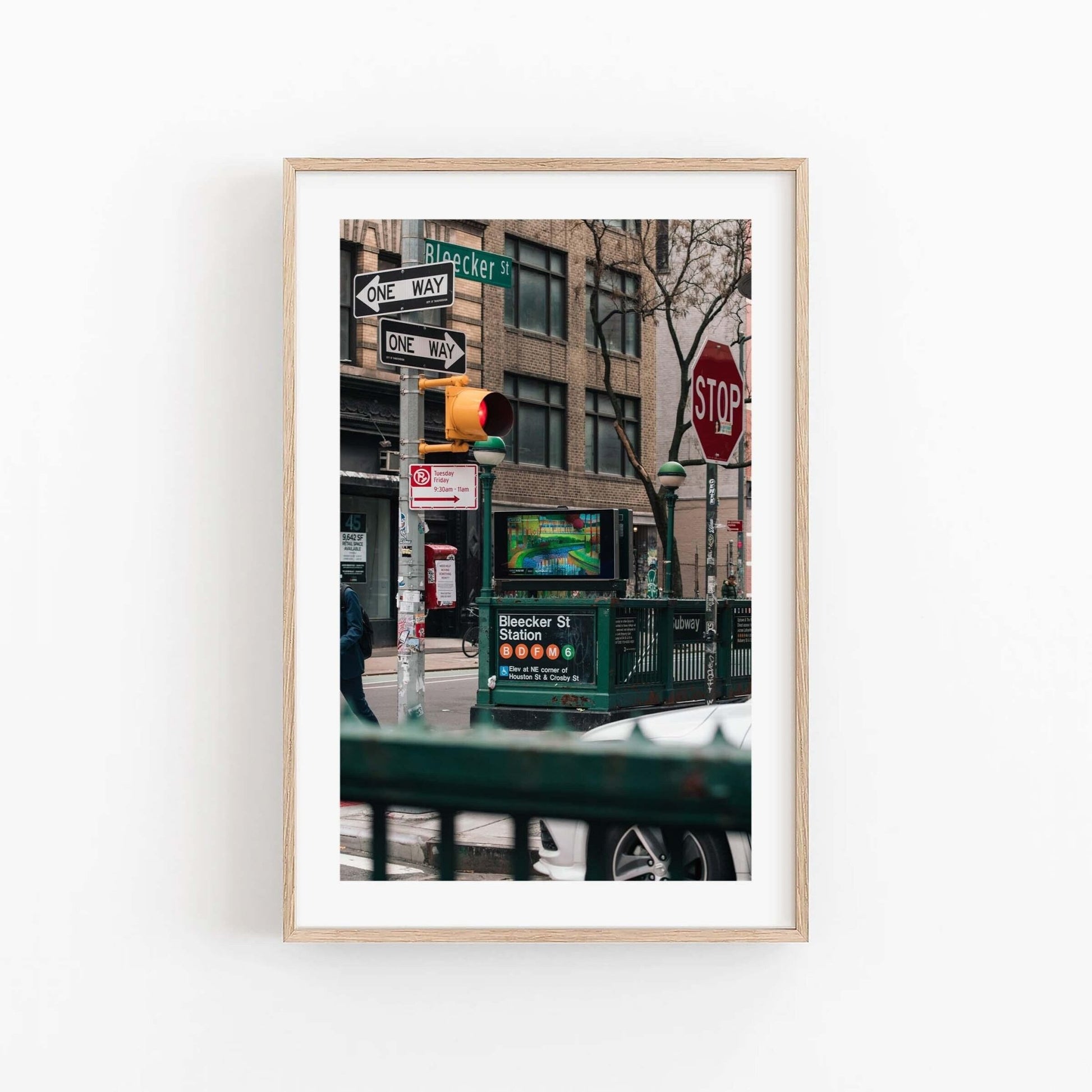 Framed photo titled Bleecker St. Station with traffic lights, street signs, and a subway entrance.