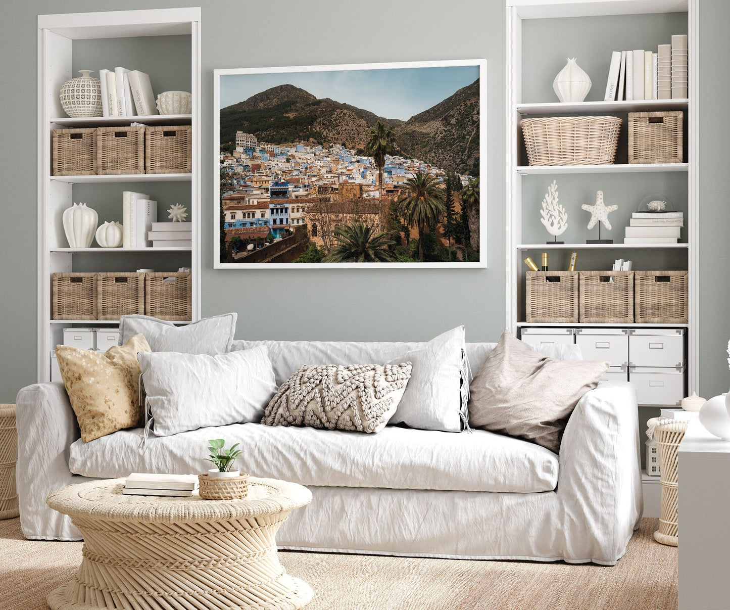 Cozy living room with a white sofa, neutral decor, and Blue City Mountains photo. Basket shelves flank the sofa.