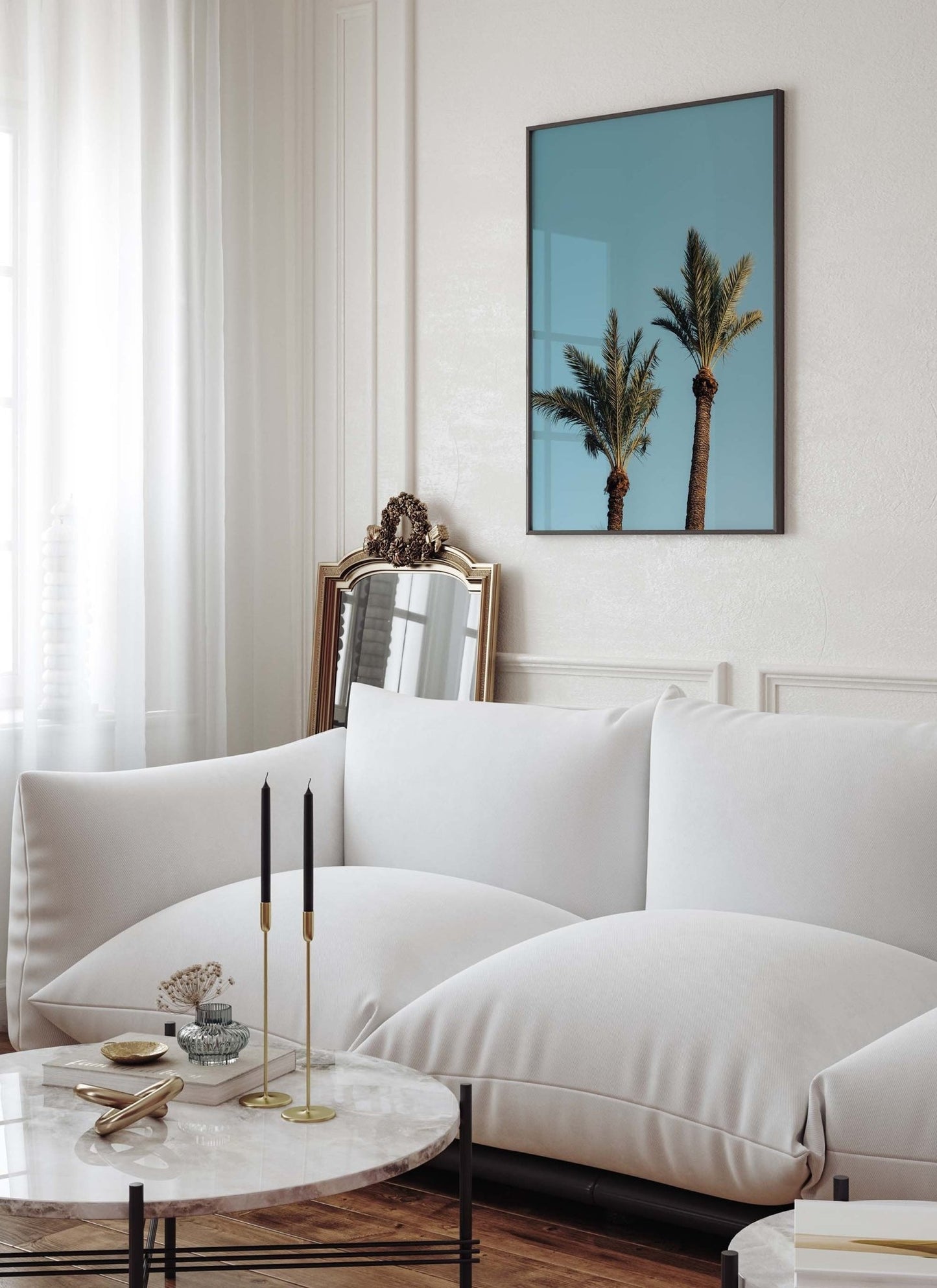 Modern living room with a white sofa, a marble coffee table, and a Blue Sky Palm painting on the wall.