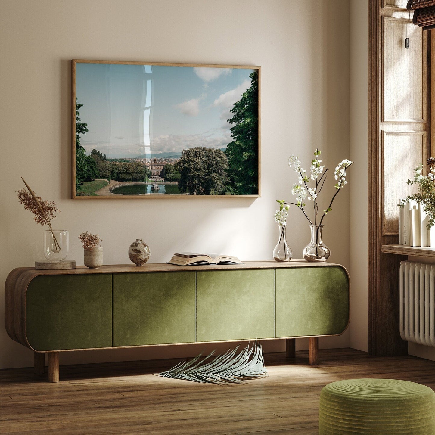 A minimalist room featuring the Boboli Gardens sideboard, art, flowers, and sunlight streaming through a window.