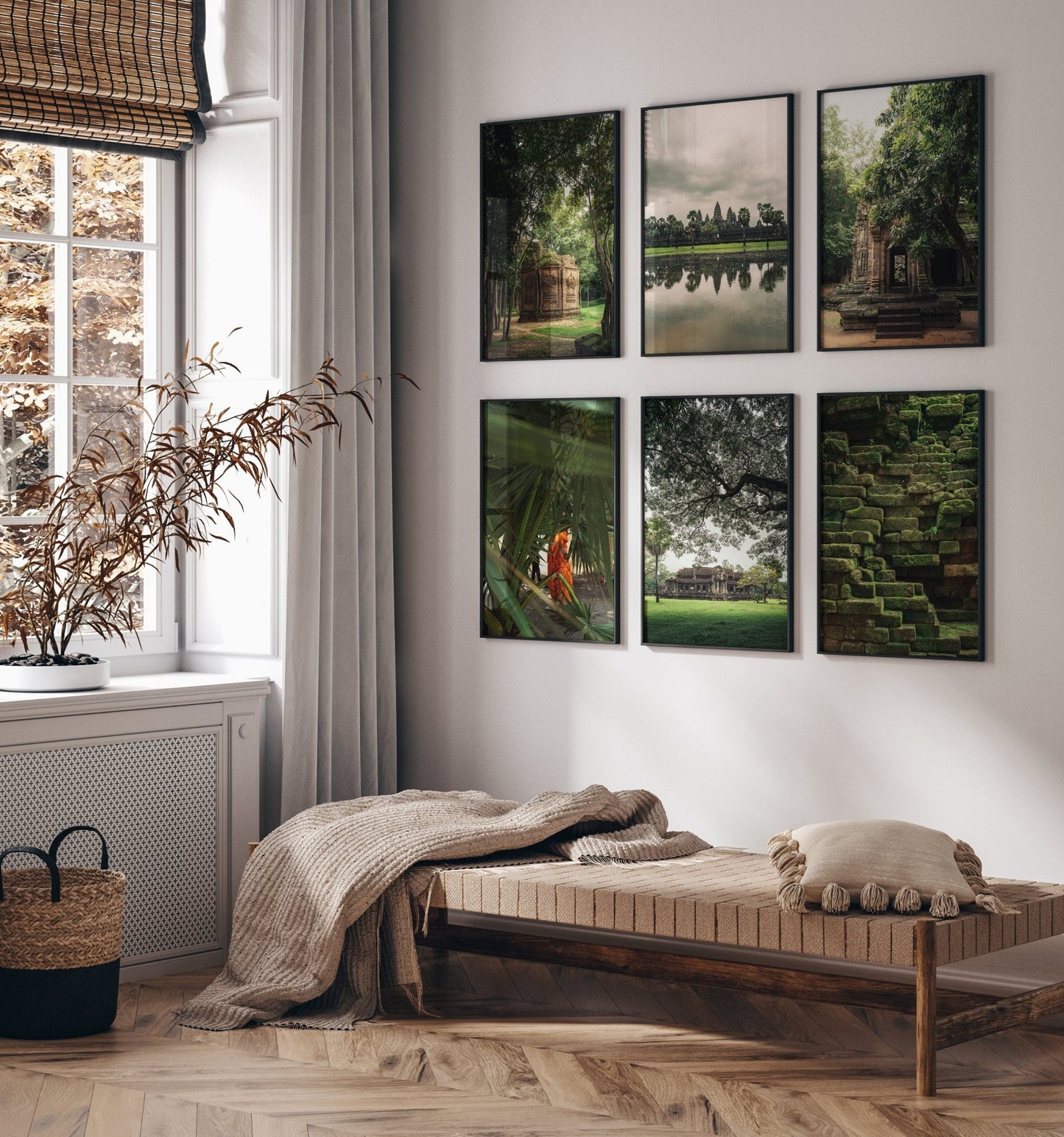 Cozy room with a daybed, cushions, and Cambodian Lush photos on the wall beside a window with sheer curtains.