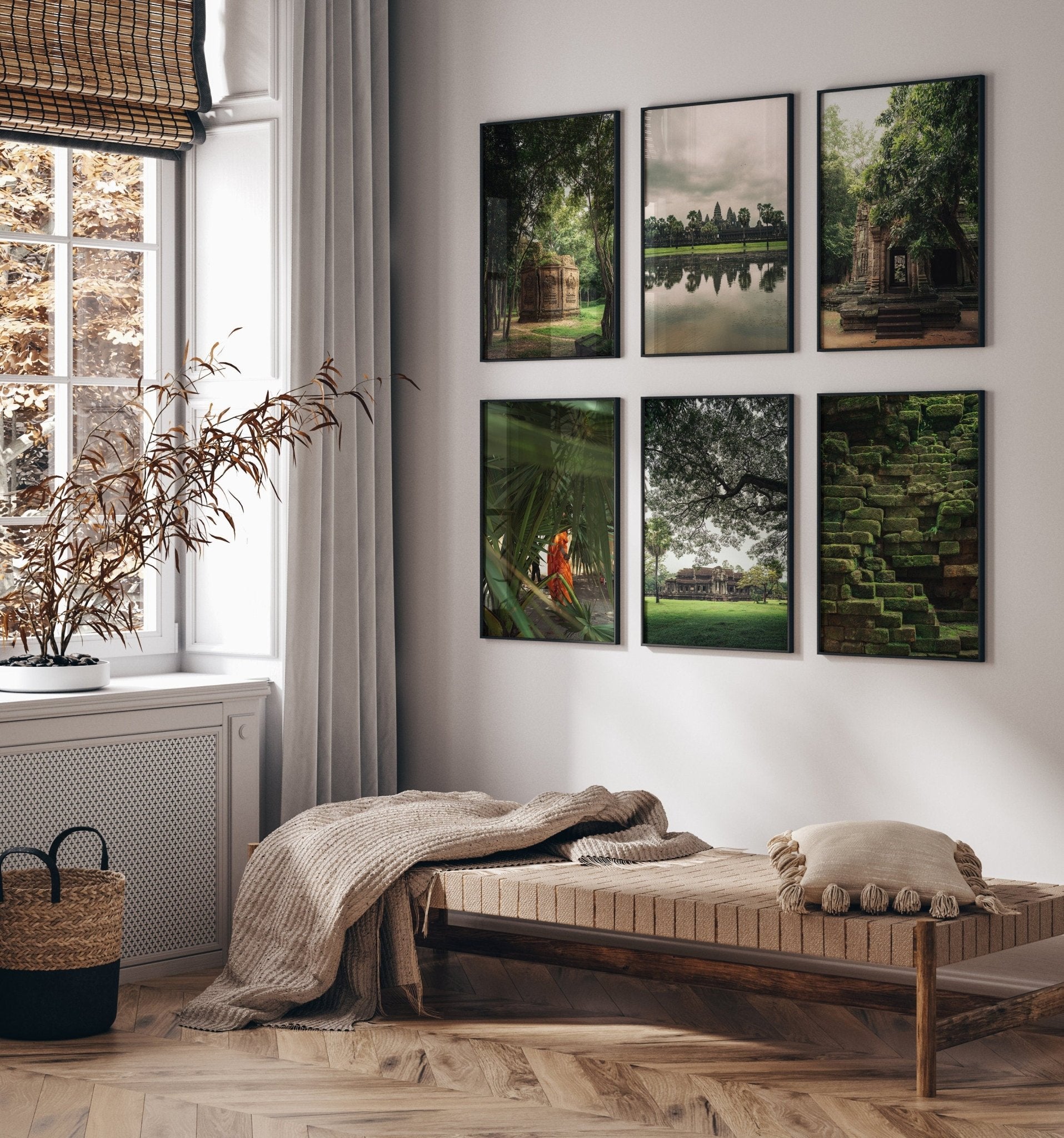 Cozy room with a daybed, cushions, and Cambodian Lush photos on the wall beside a window with sheer curtains.