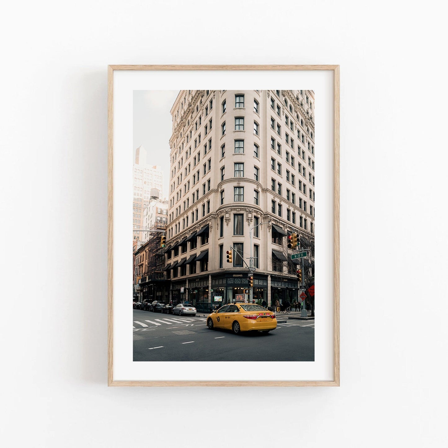 Cecconis framed photo: city street with a yellow taxi in front of a historic-style corner building.