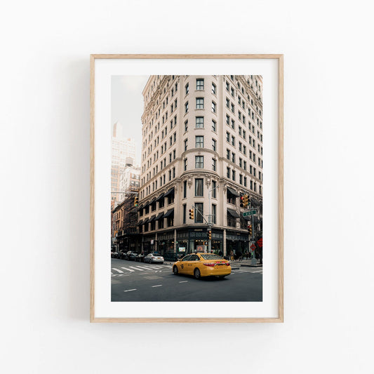 Cecconis framed photo: city street with a yellow taxi in front of a historic-style corner building.