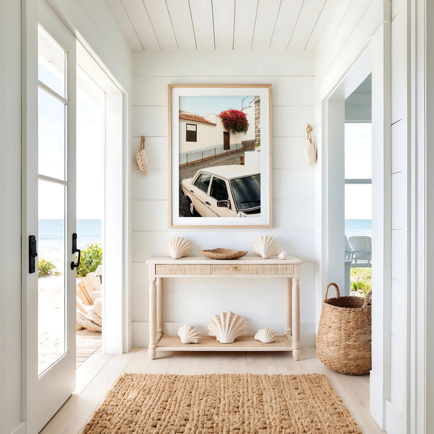 Bright, coastal entryway featuring the Classic in Bloom rug, seashell decor, framed car photo, and beach view.