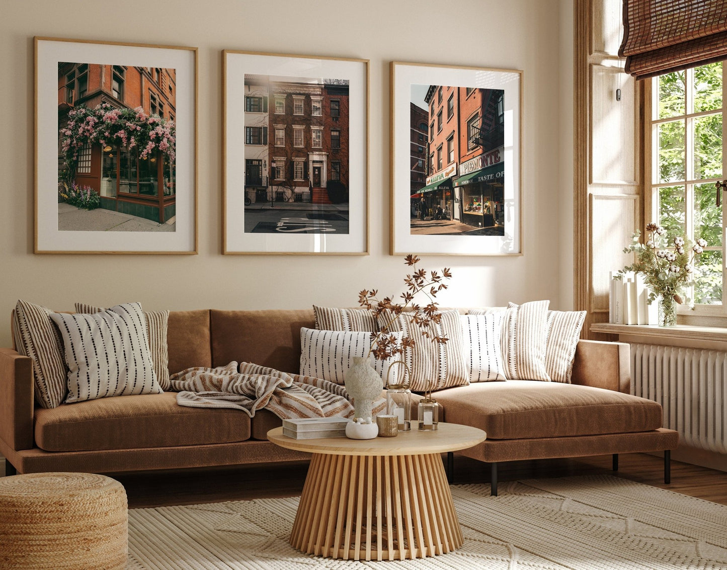 Cozy living room with brown sofa, patterned pillows, and Classic New York - Set of 3 framed art above. Large window with light.