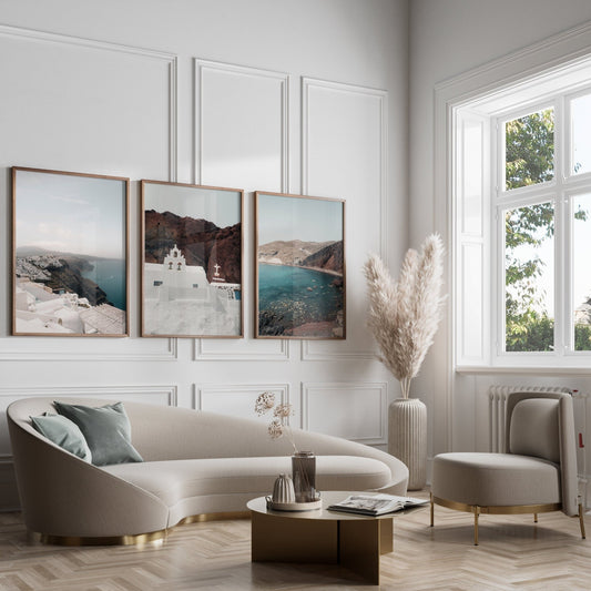Elegant living room with a cream sofa, round table, pampas grass, large windows, and Colors of Santorini wall art.