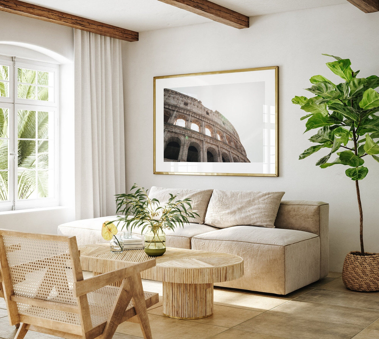 Stylish living room with beige furniture, large plant, and the Colosseum I framed photo on the wall.