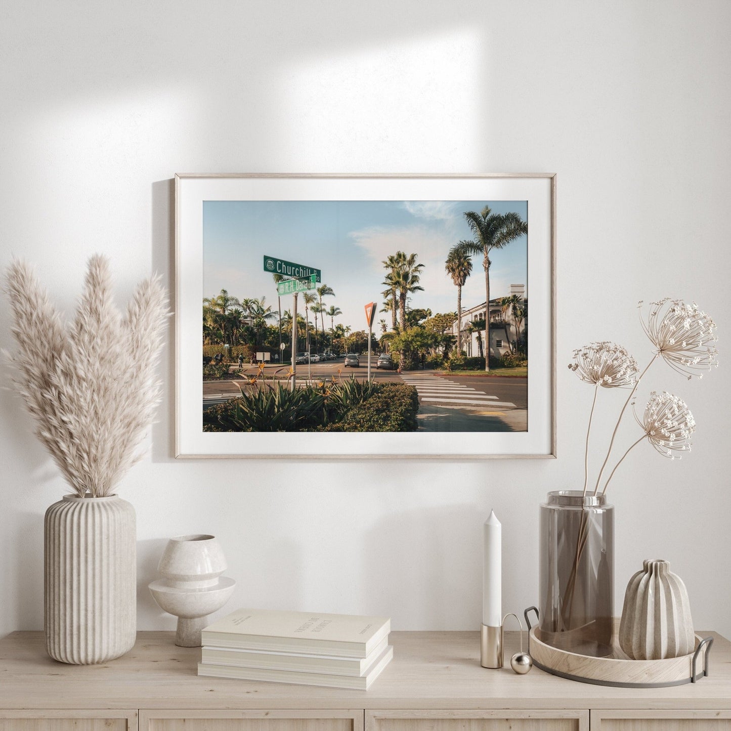 Coronado Crossing framed photo on a light wood table with decorative vases and books.