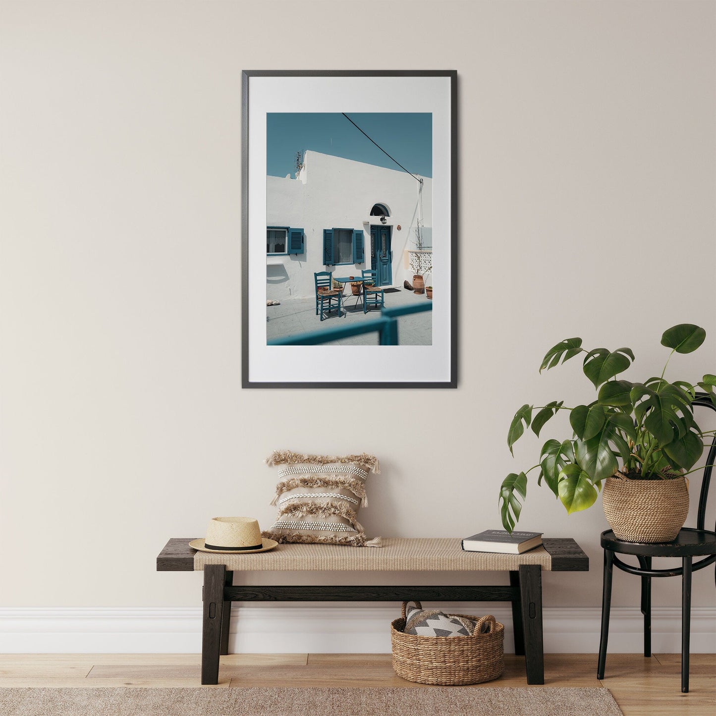 Cozy Haven photo above a bench with cushions, a hat, and a plant nearby in a sunny courtyard setting.