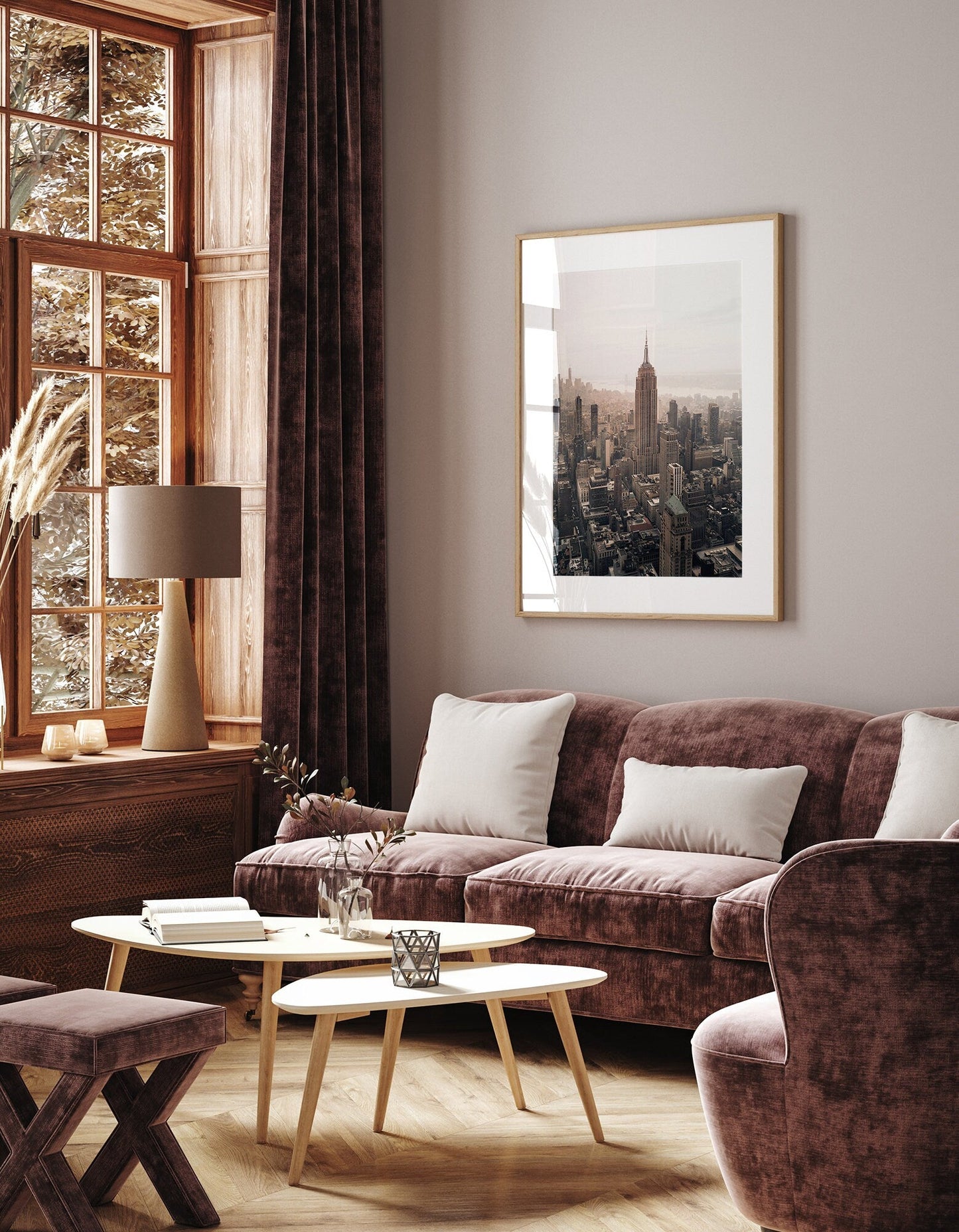 Cozy living room with velvet furniture, an Empire State Building photo on the wall, and large windows with autumn views.
