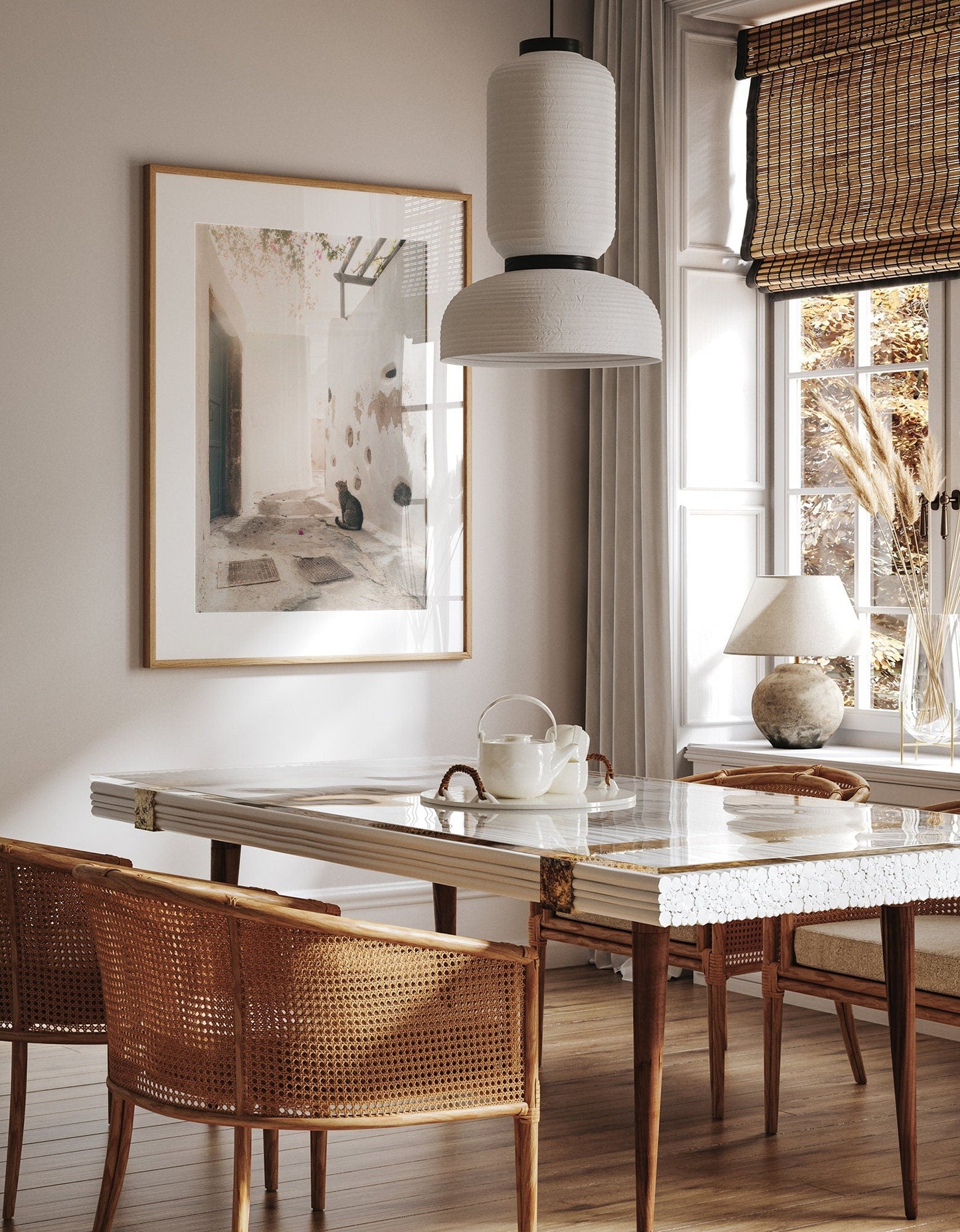 Stylish dining area with the Emporio Cat table, wicker chairs, pendant light, and wall artwork.