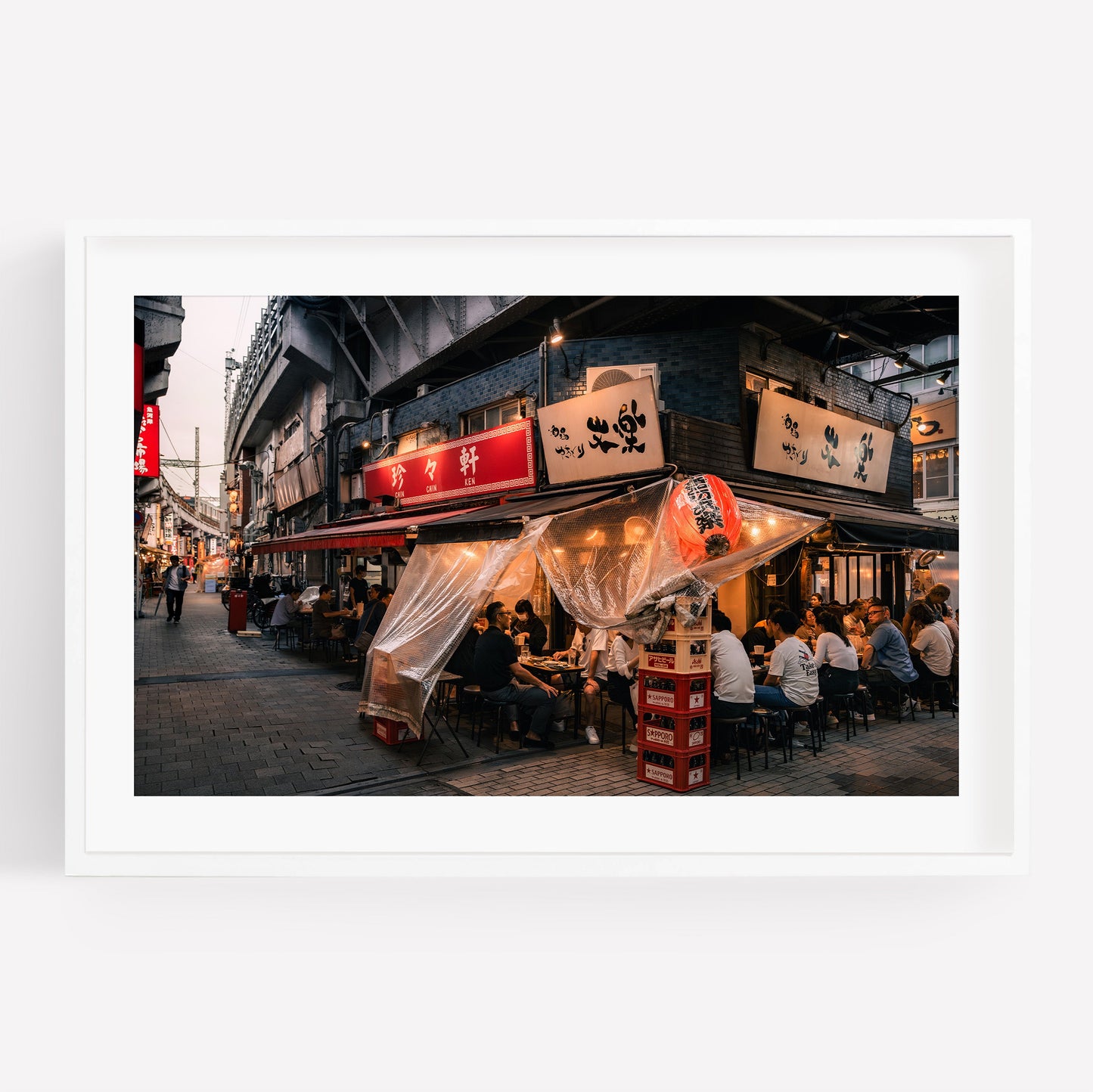 Flavors Of Ueno: Outdoor dining under warm lights and plastic covers on a lively street at dusk.