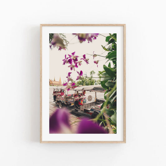 A framed photo titled Floral Tuktuk shows two tuk-tuks obscured by purple flowers and temples in the background.