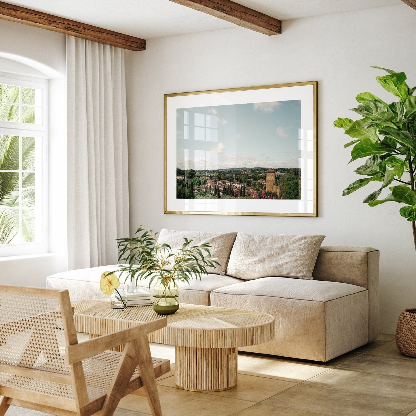 Cozy living room with the Florence Countryside, wooden coffee table, green plant, and framed artwork on the wall.