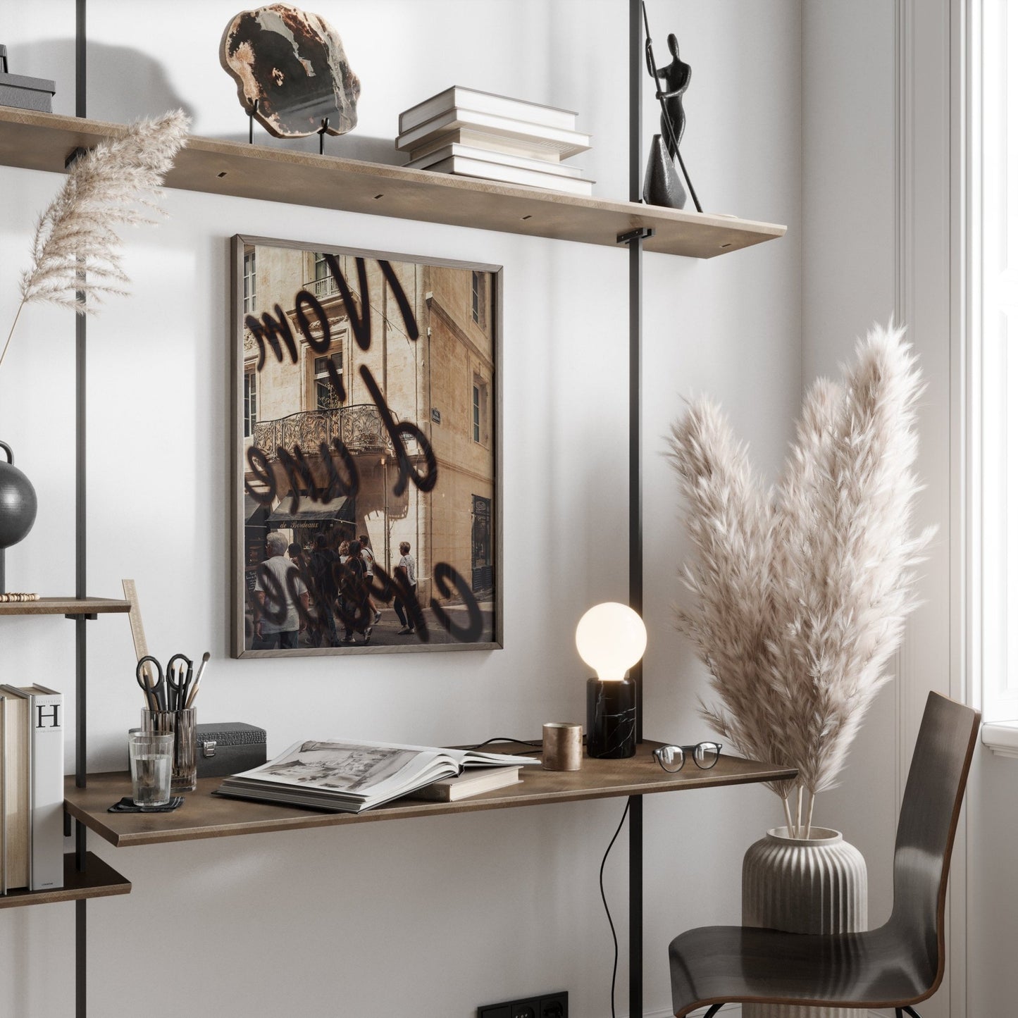 The French Charm desk is styled with books, a lamp, pampas grass, and decor on an overhead shelf with a street photo.