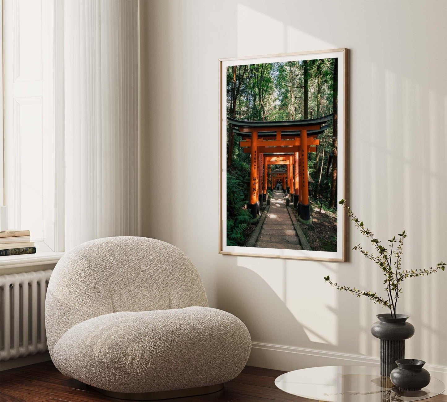 Cozy room with a plush chair, small table, and framed artwork titled Fushimi Inari Taisha I on the wall.