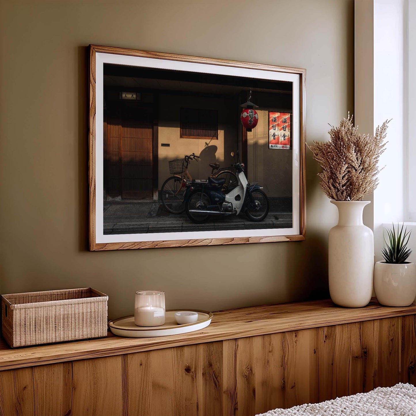 The Golden Shadow photo, framed, features a parked motorbike on a wooden console table with a vase and candle.