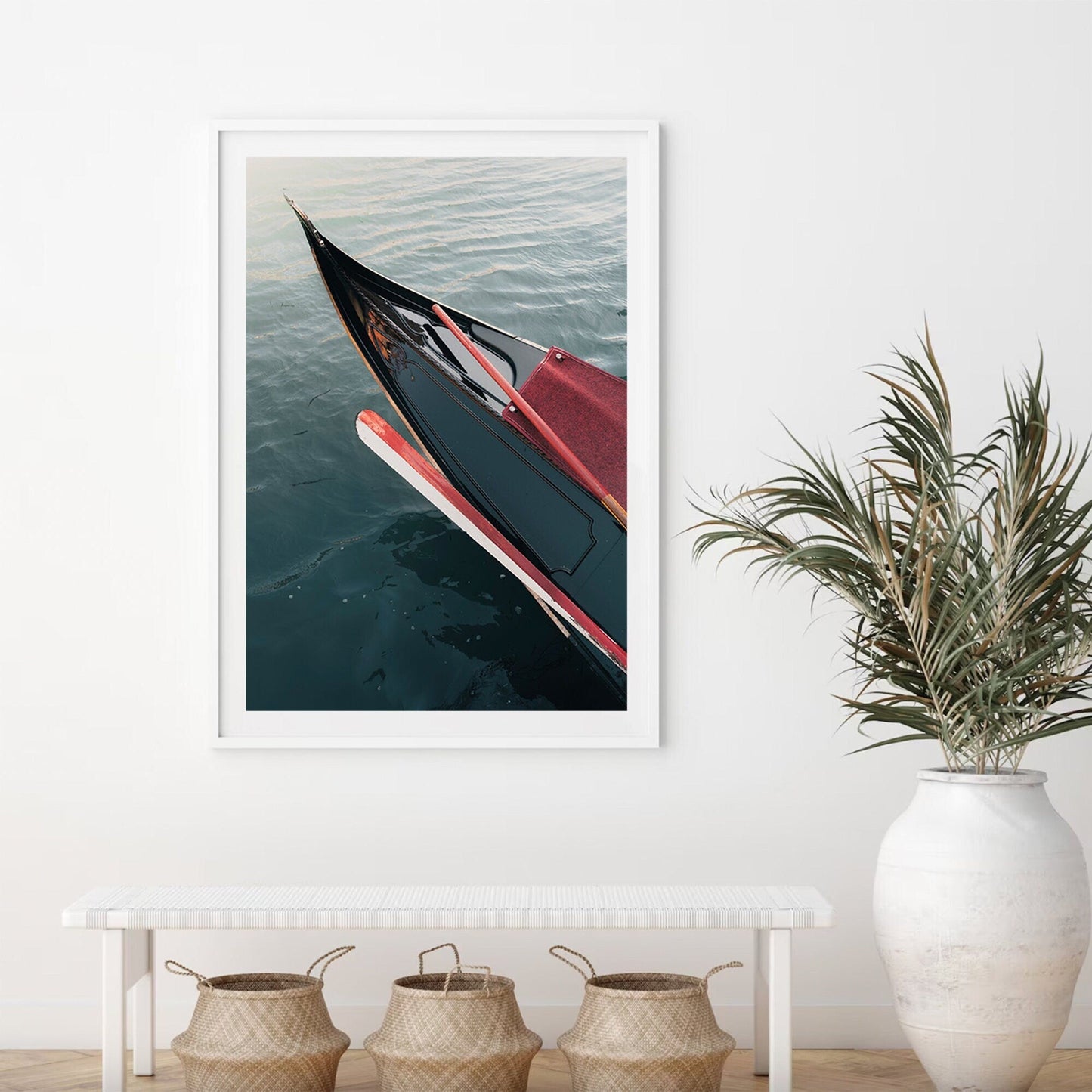 Framed Gondola photo hangs above a bench with three baskets and a potted plant.