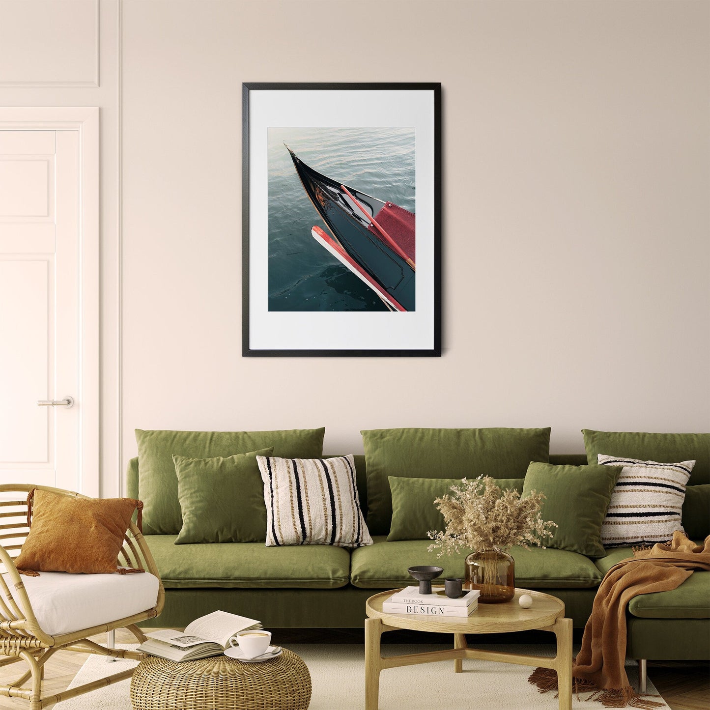 Cozy living room with a green sofa, striped pillows, and a framed picture of the Gondola on the wall.