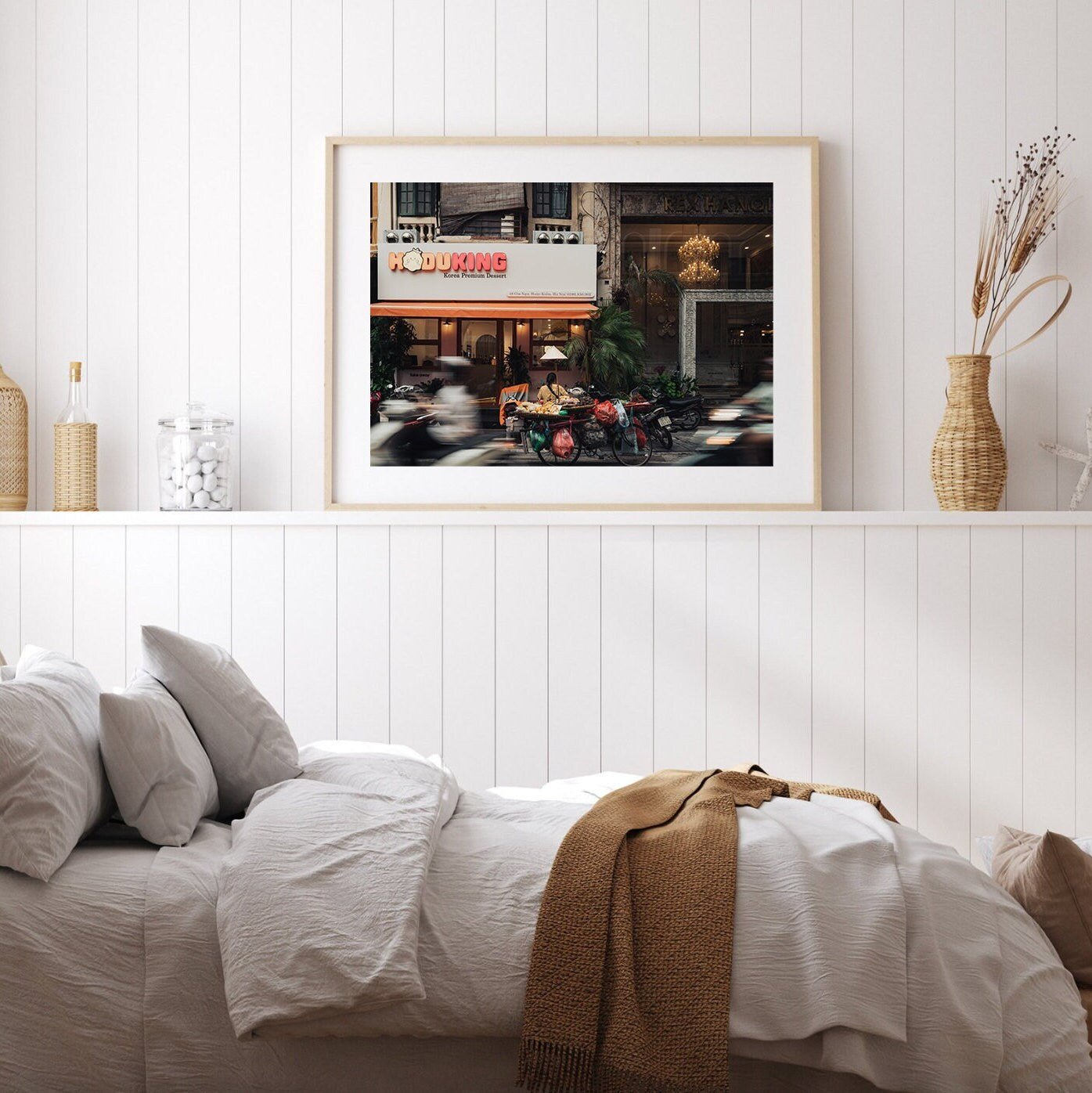Minimalist bedroom with Hanoi Street Blur framed above the bed, offering cozy and modern decor.