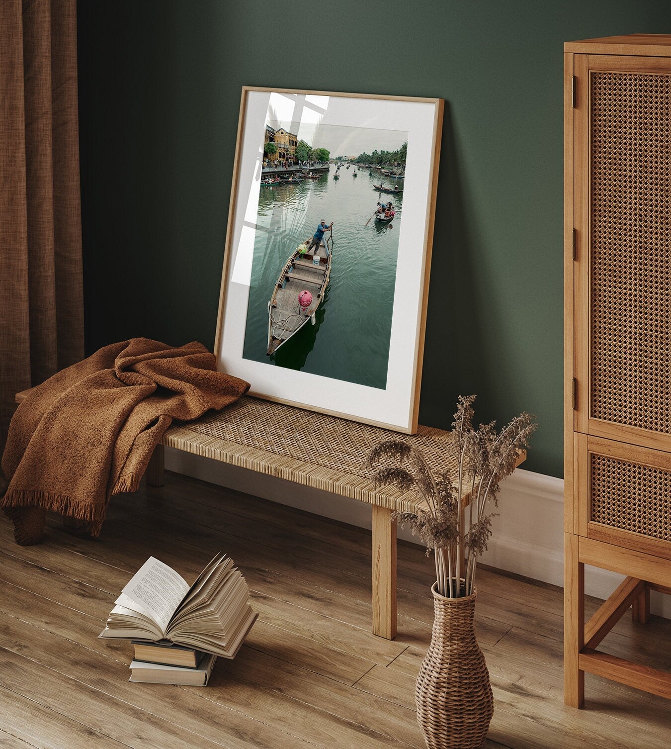 Hoi An Row framed photo on bench, woven cabinet, dried grass vase, and open book on wooden floor.