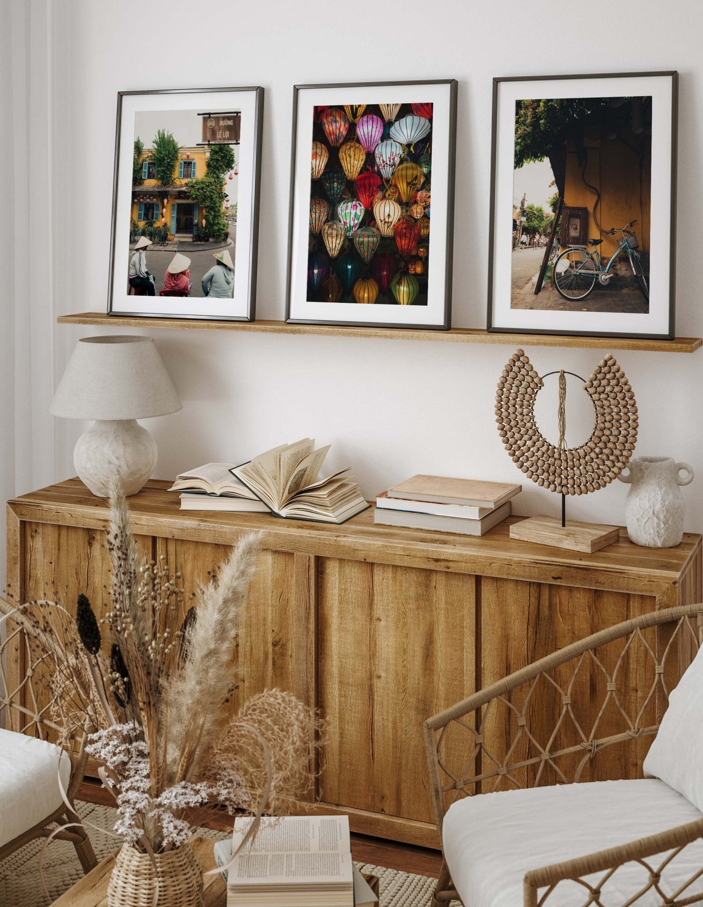Cozy room with Hoi An Vietnam - Set of 3, wooden furniture, decorative vases, books, and framed photos on a shelf.