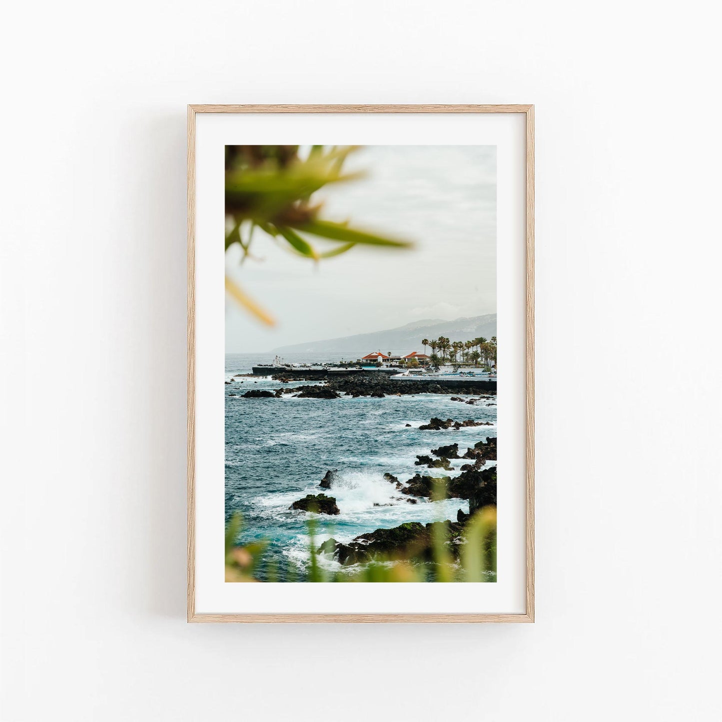 Set of 3 framed photos: Puerto de la Cruz rocky coastline with waves, buildings, palms, and a cloudy sky.