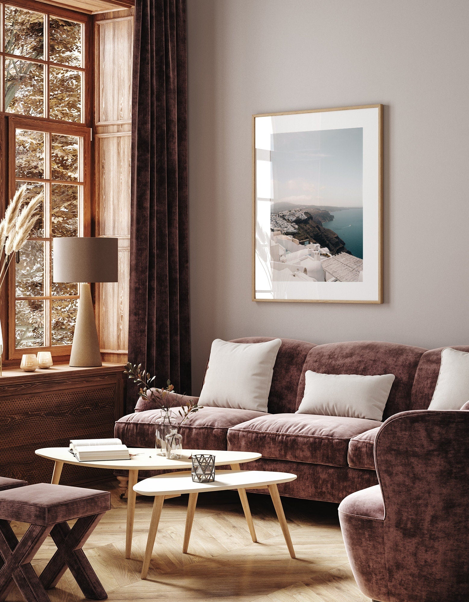 Cozy living room featuring plush mauve Imerovigli furniture, a large window, and a framed seaside photo on the wall.