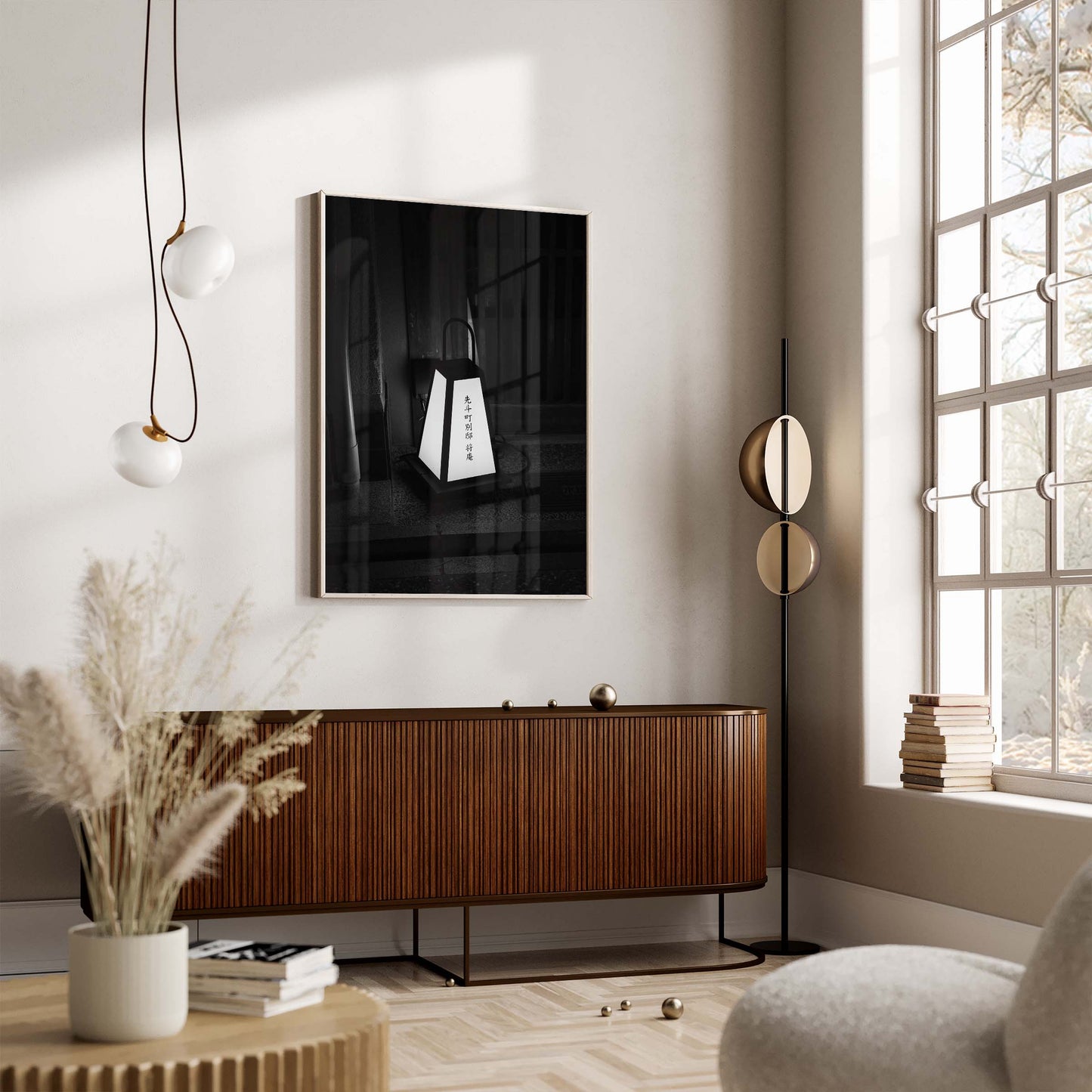 A modern living room with the Kyoto Lantern I Black and White, wall art, pampas grass, and large sunlit windows.