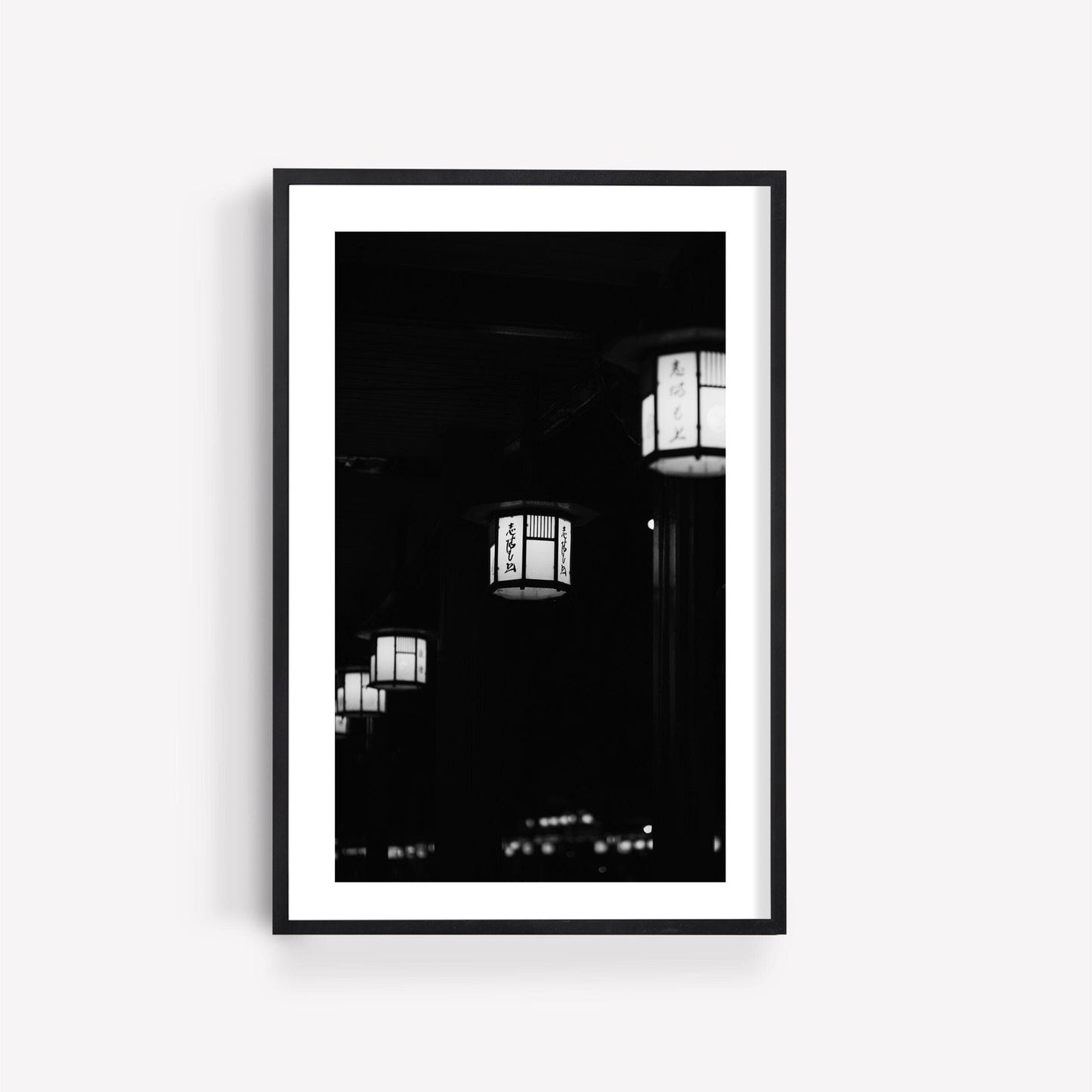 Kyoto Lanterns II Black and White: Framed photo of Japanese lanterns with writing, displayed on a white background.