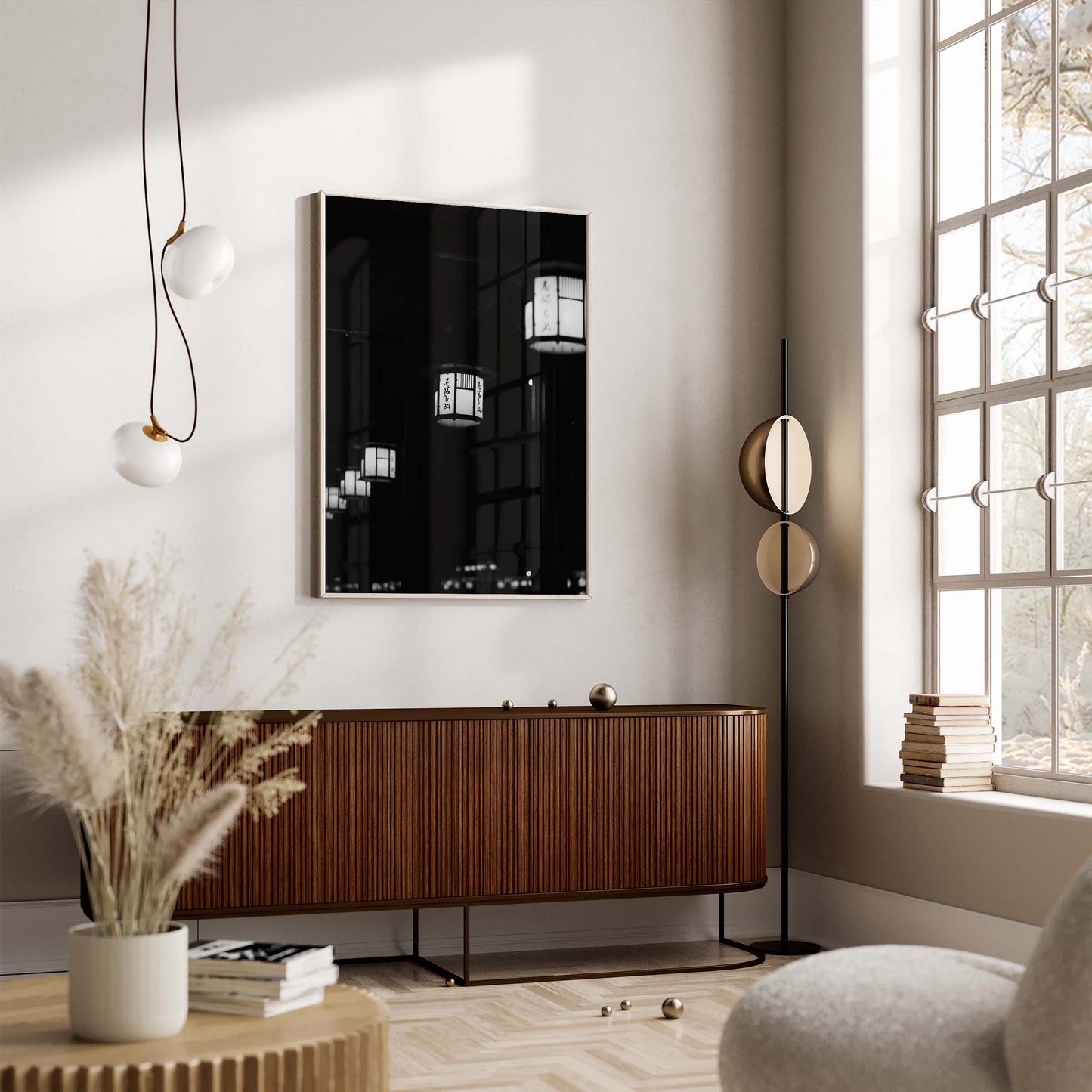 Modern living room with wooden sideboard, Kyoto Lanterns II Black and White wall art, pendant lights, and sunlit window.