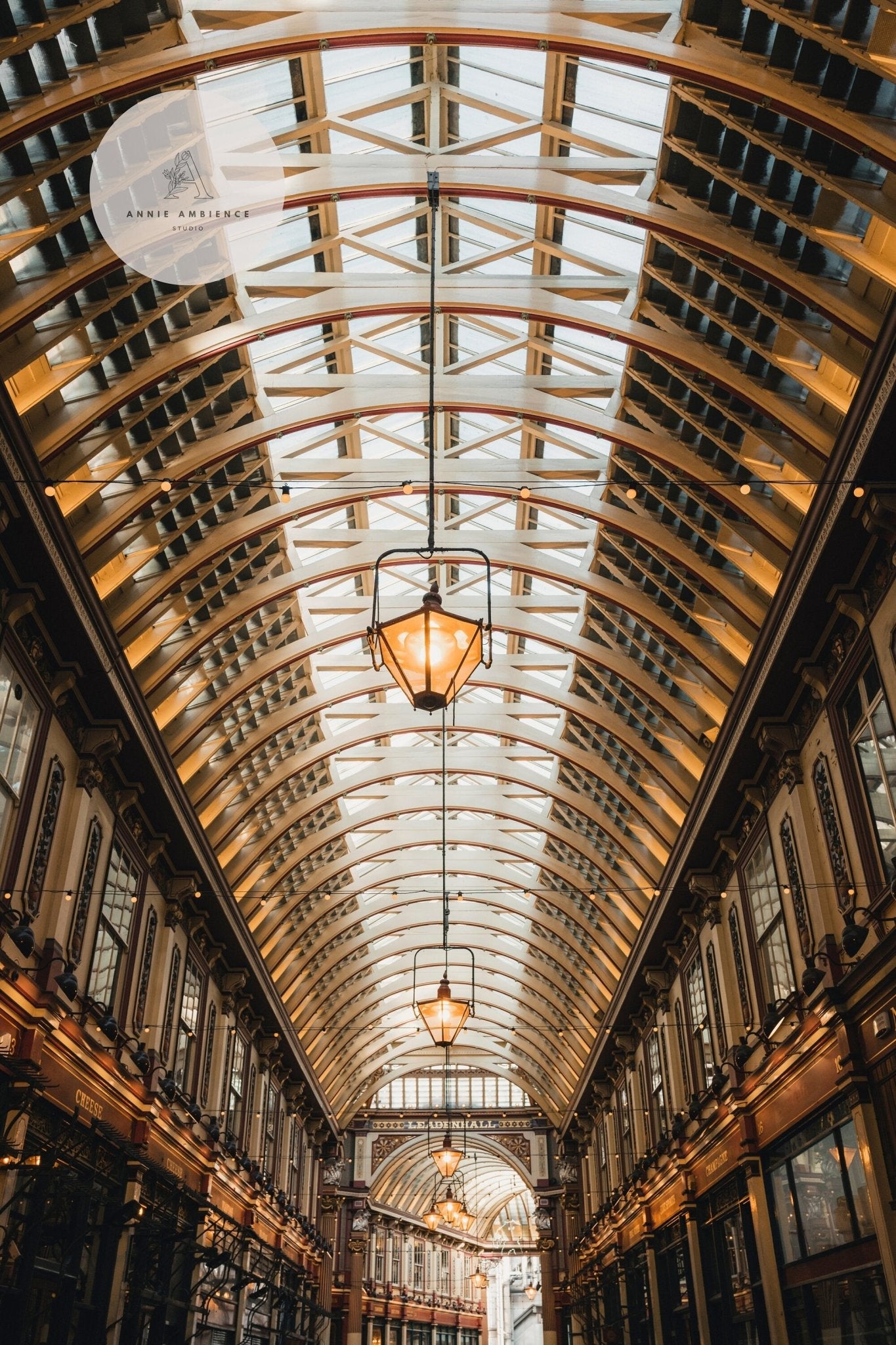 A view of Leadenhall Ceiling showcasing intricate metalwork and hanging yellow lamps.