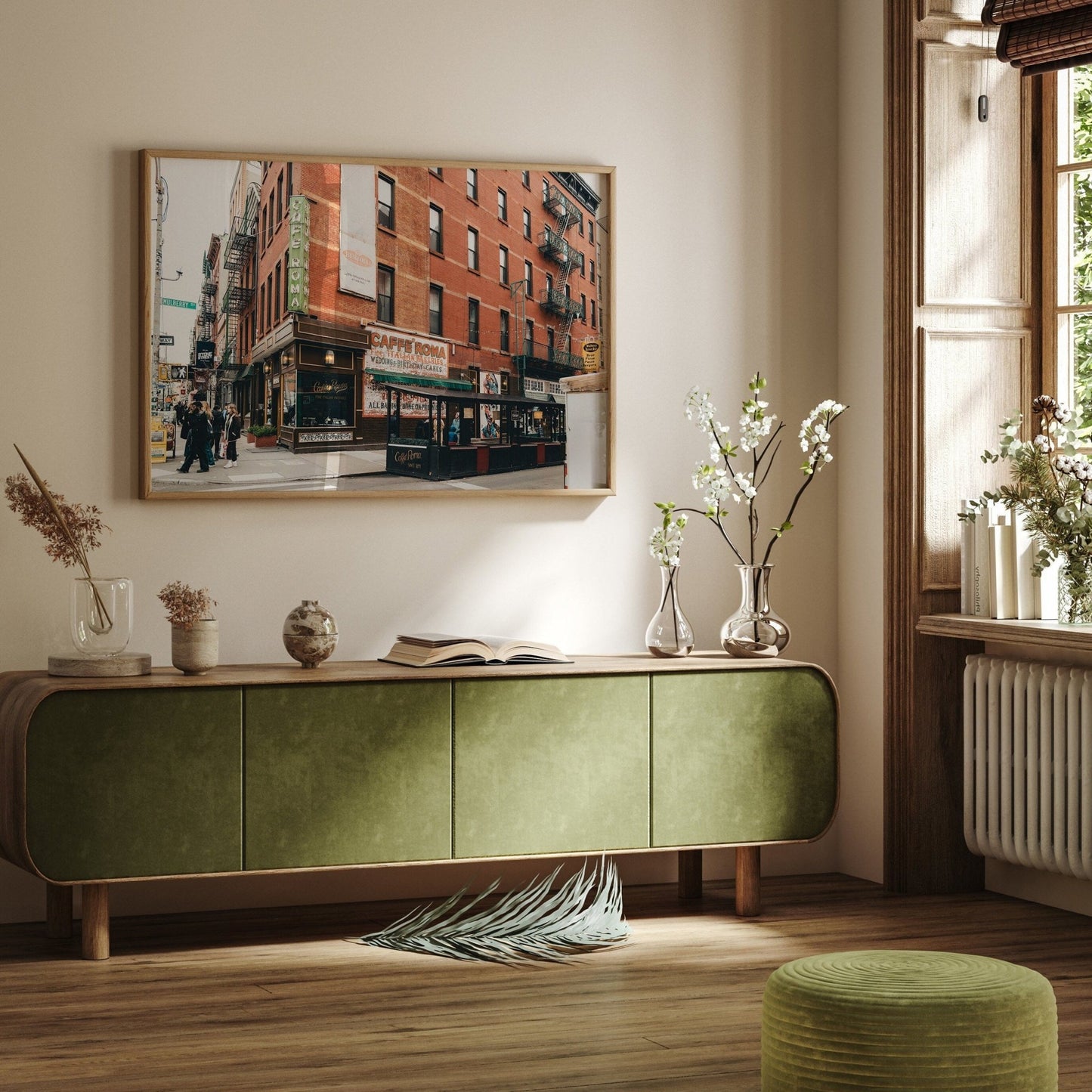 A chic living room with Little Italy II, wall art, flower-filled vases, and sunlight streaming through the window.