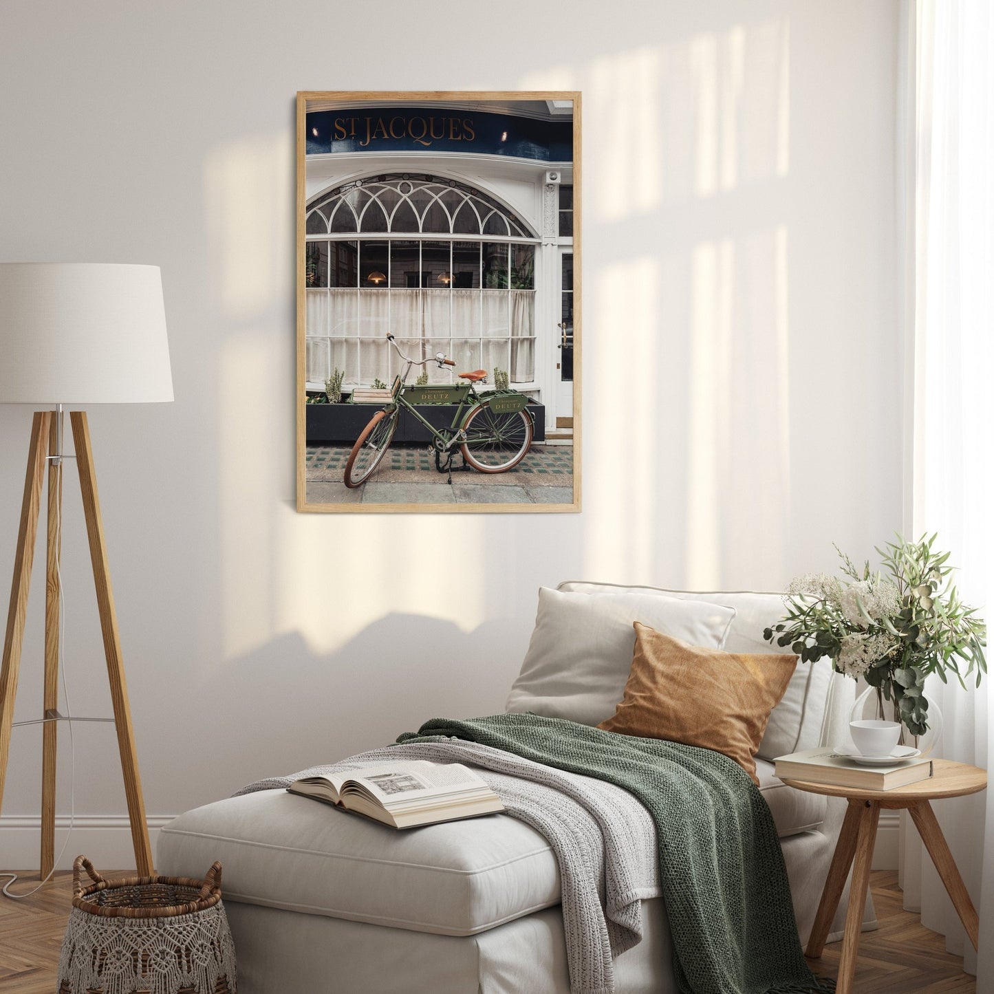 Cozy room with a bed, a leaning lamp, a small table, and a framed London Bike photo on the wall.