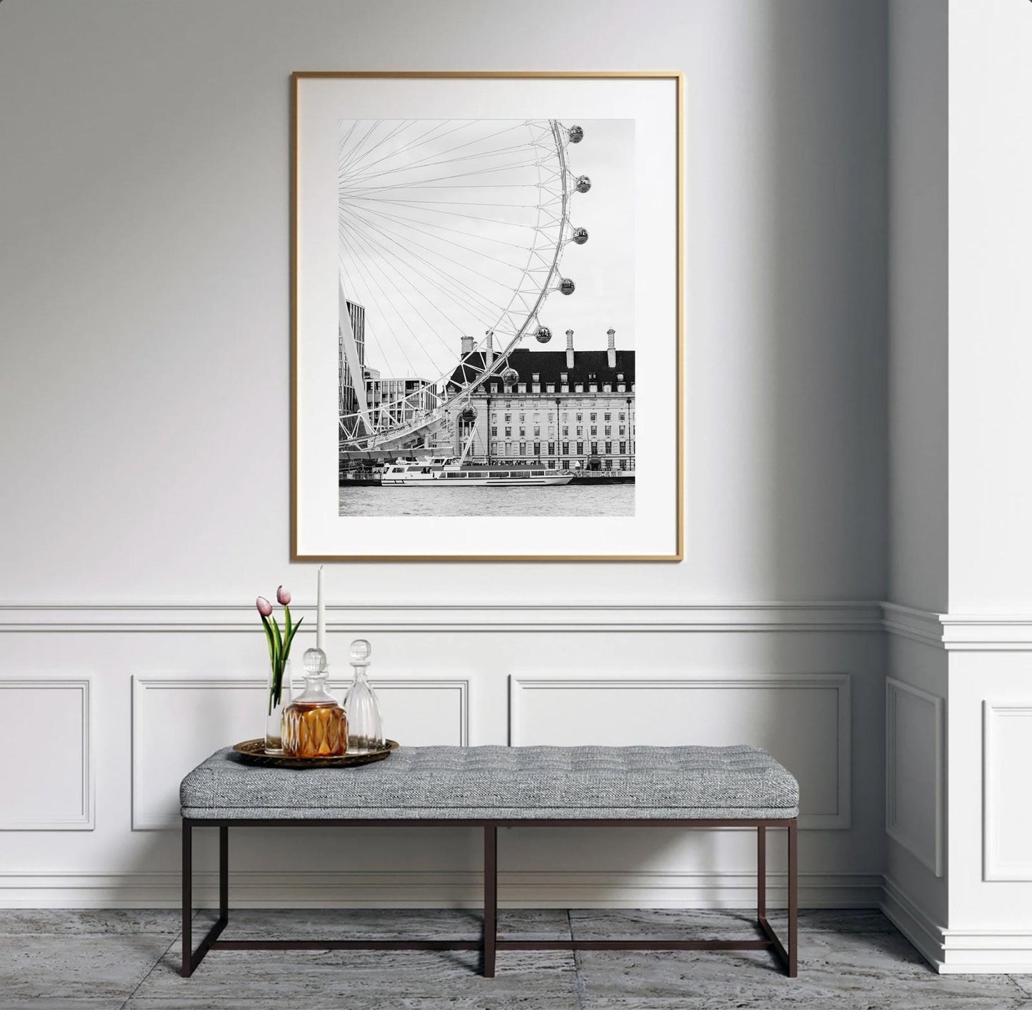 The London Eye Black and White framed photo hangs above a bench with a tray, flowers, and a decanter.