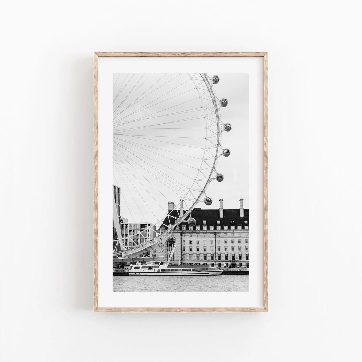 Framed London Eye Black and White photo on a white wall.