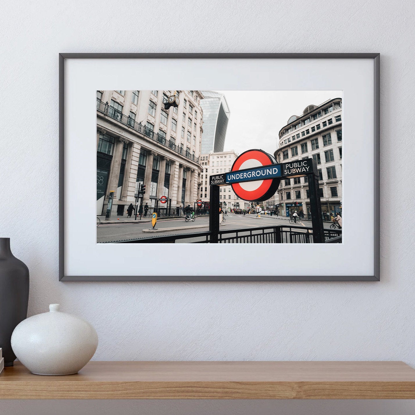 London Tube photo on a shelf with a black and white vase.
