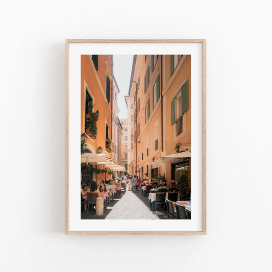 Lunch in Rome framed photo: Sunlit narrow street with cafes and outdoor dining.
