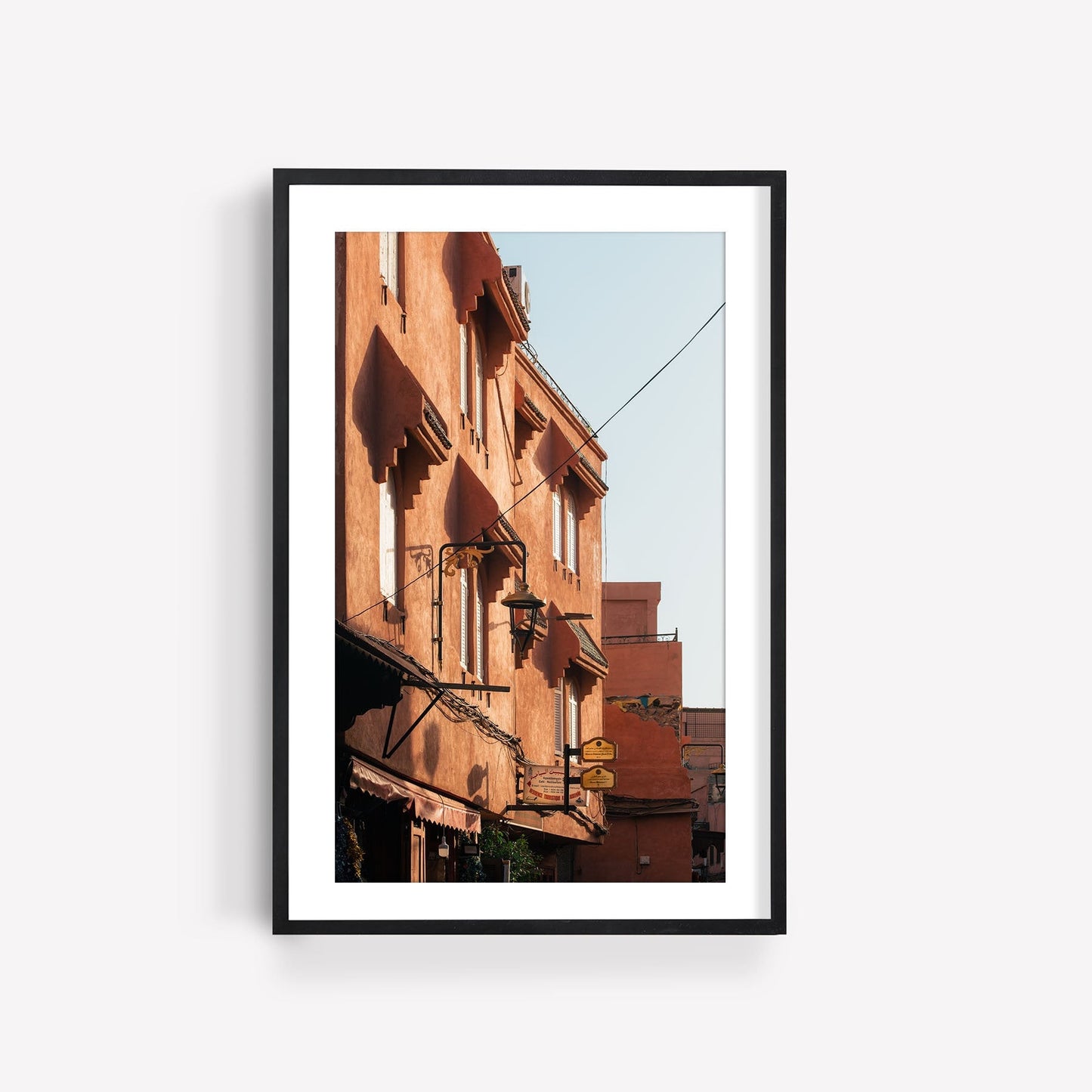 Photo of the Marrakesh Red Building with sunlit terracotta architecture and balconies.