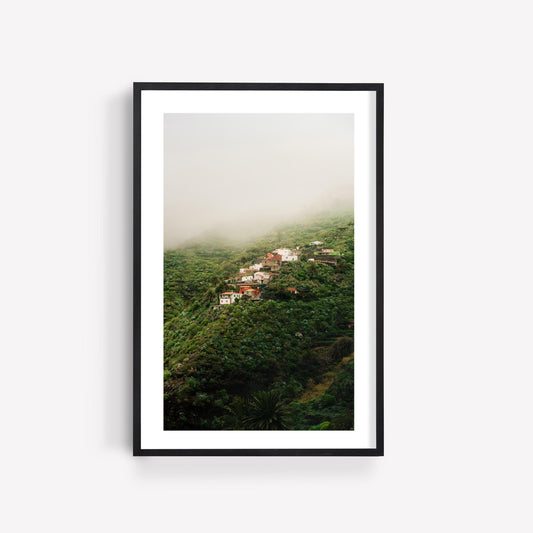 Framed photo, "Masca Mist": misty green hills and clustered houses nestled in lush vegetation under foggy skies.